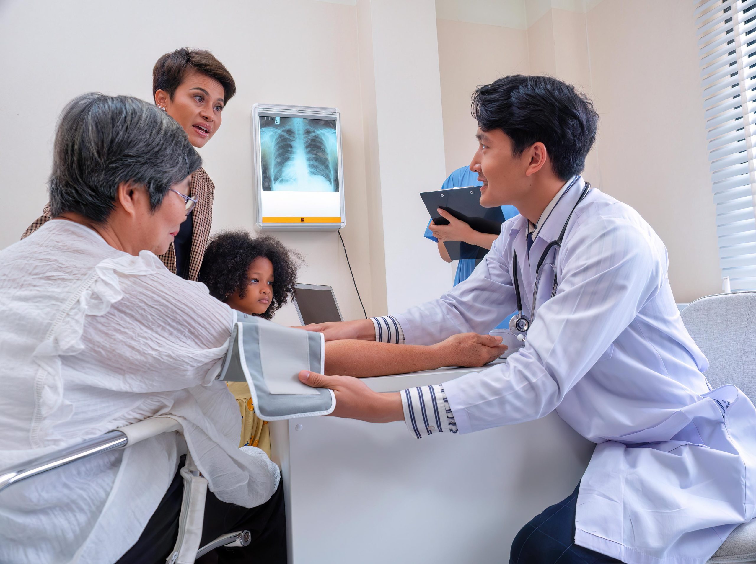 healthcare worker checking the blood pressure of a patient