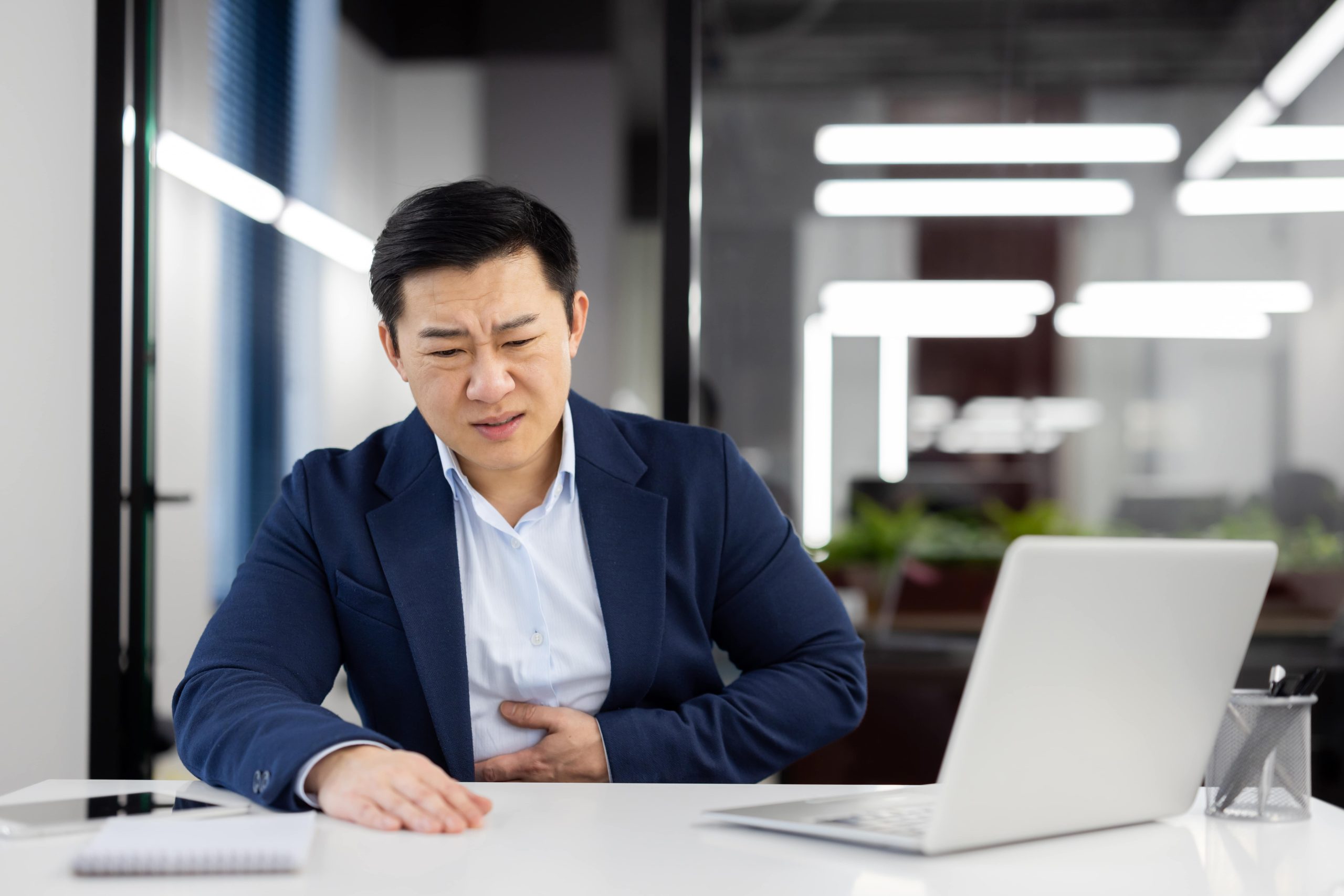 man with stomach pain and his hand on his stomach