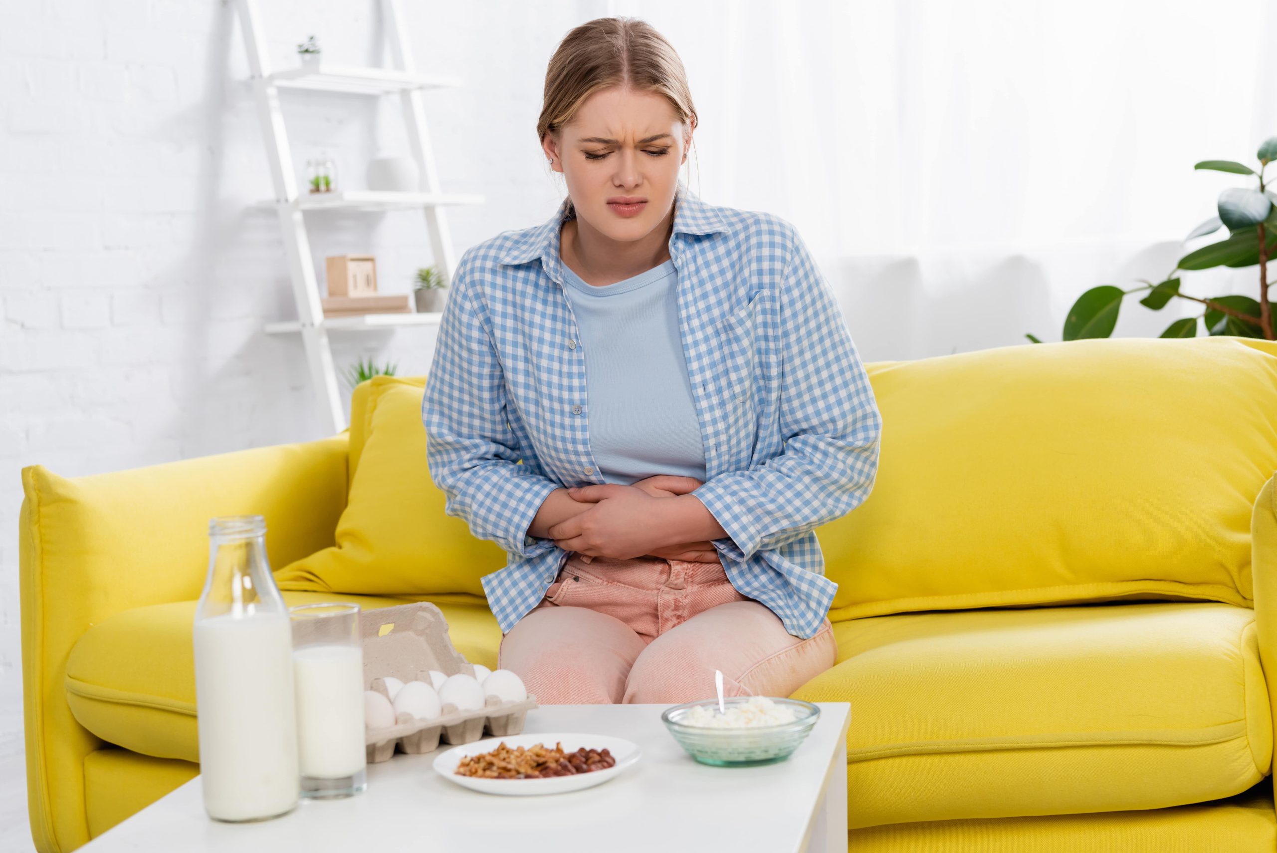 woman with a stomachache looking at food