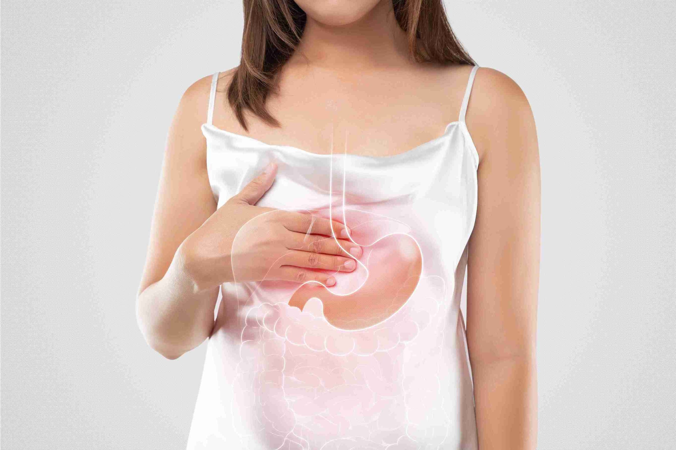 woman holding with her hand on the upper portion of her stomach