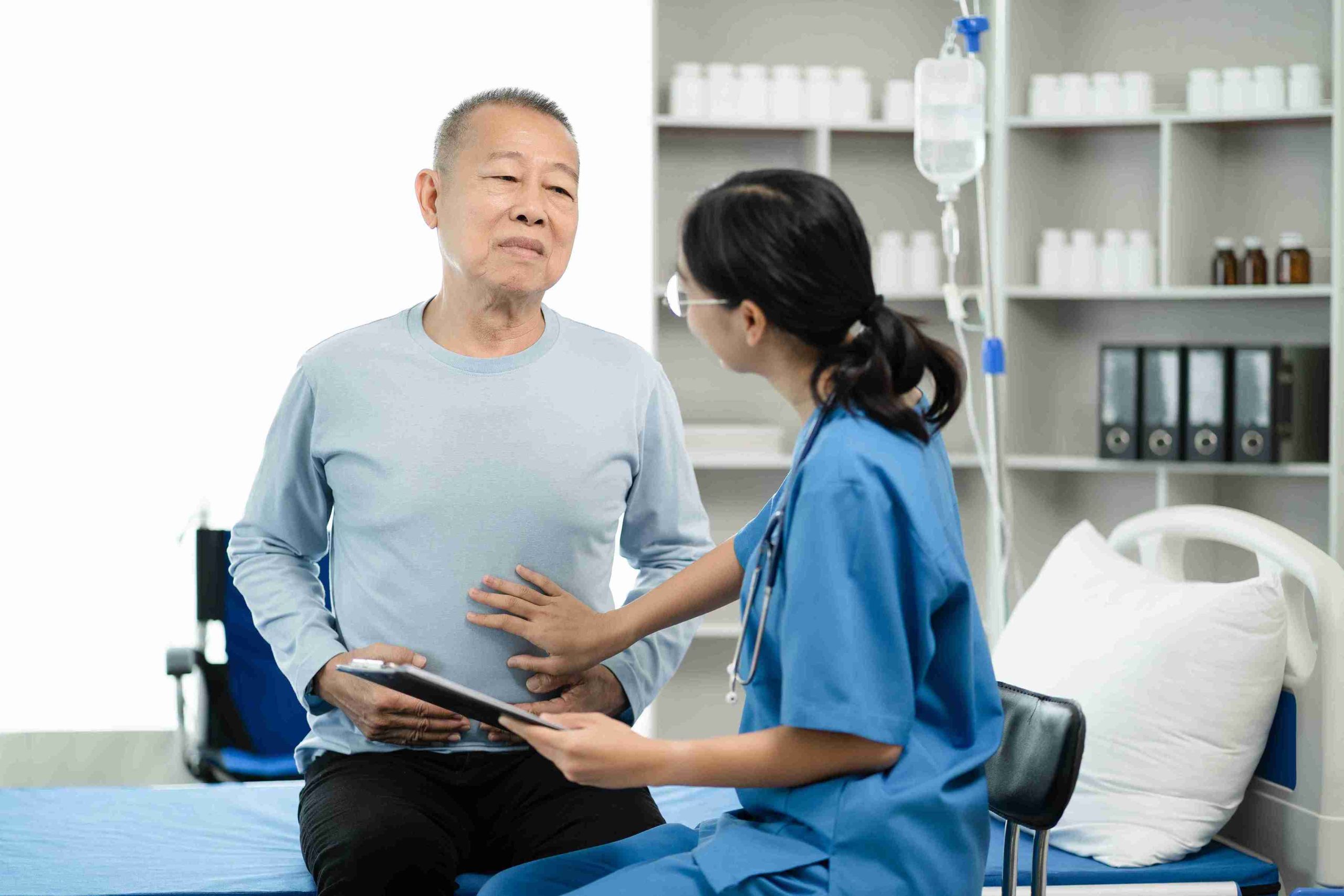male elderly patient examined by a young female doctor