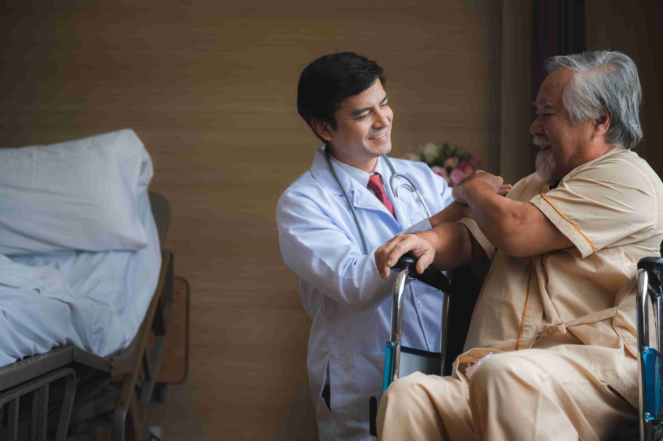 doctor assisting a patient sitting on a wheelchair