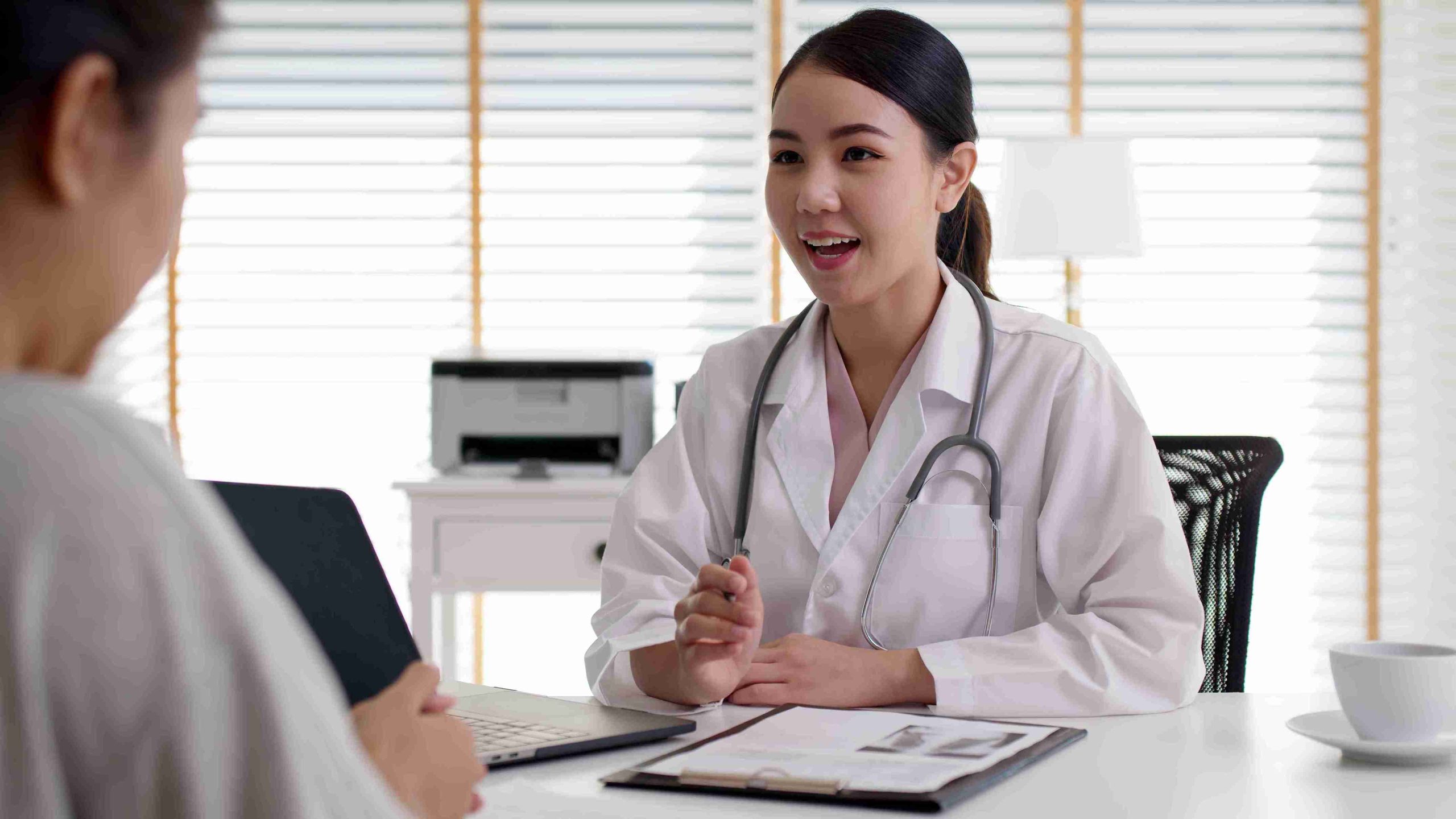 female doctor speaking with a patient