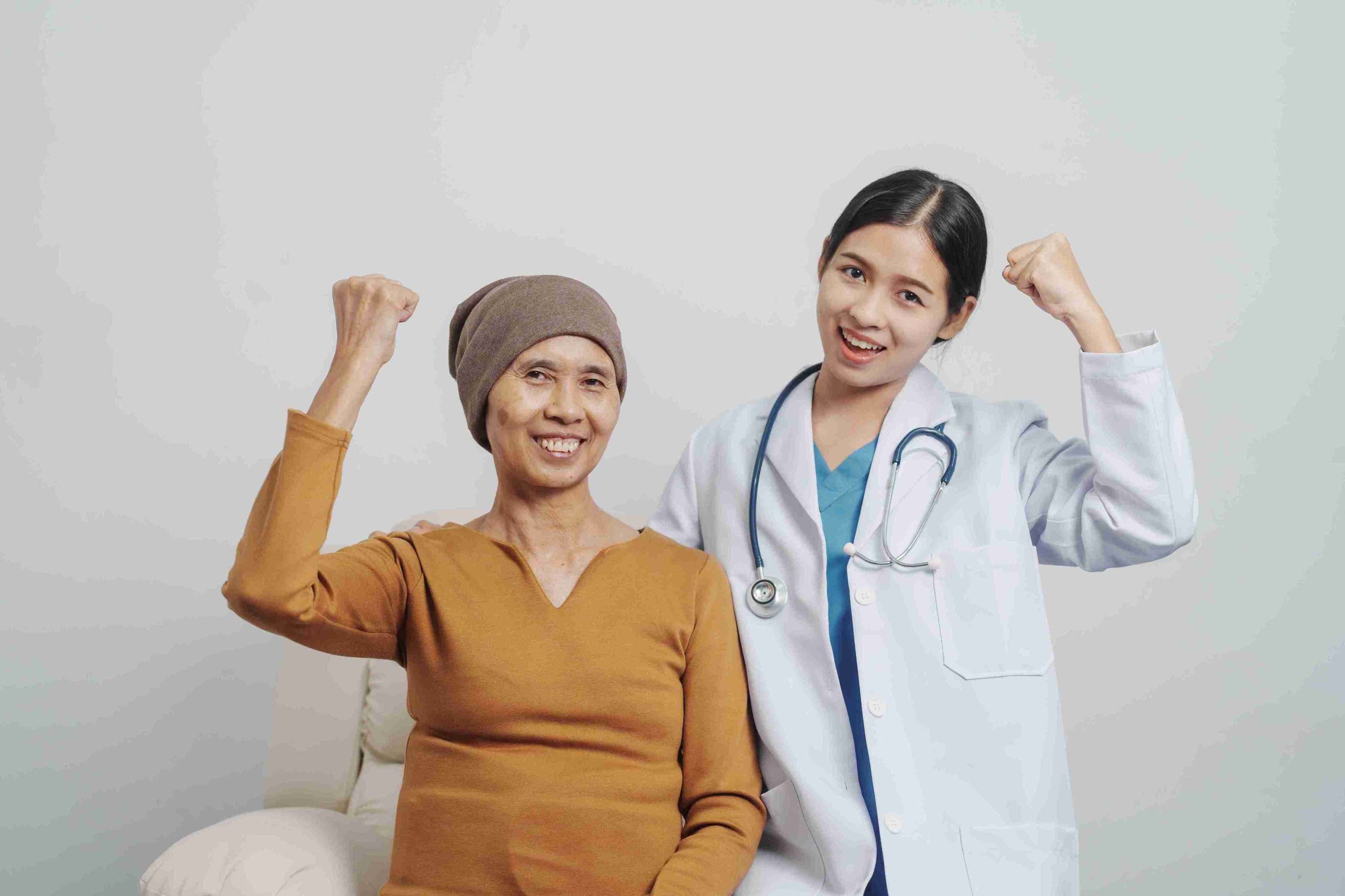 female cancer patient with doctor smiling at the camera
