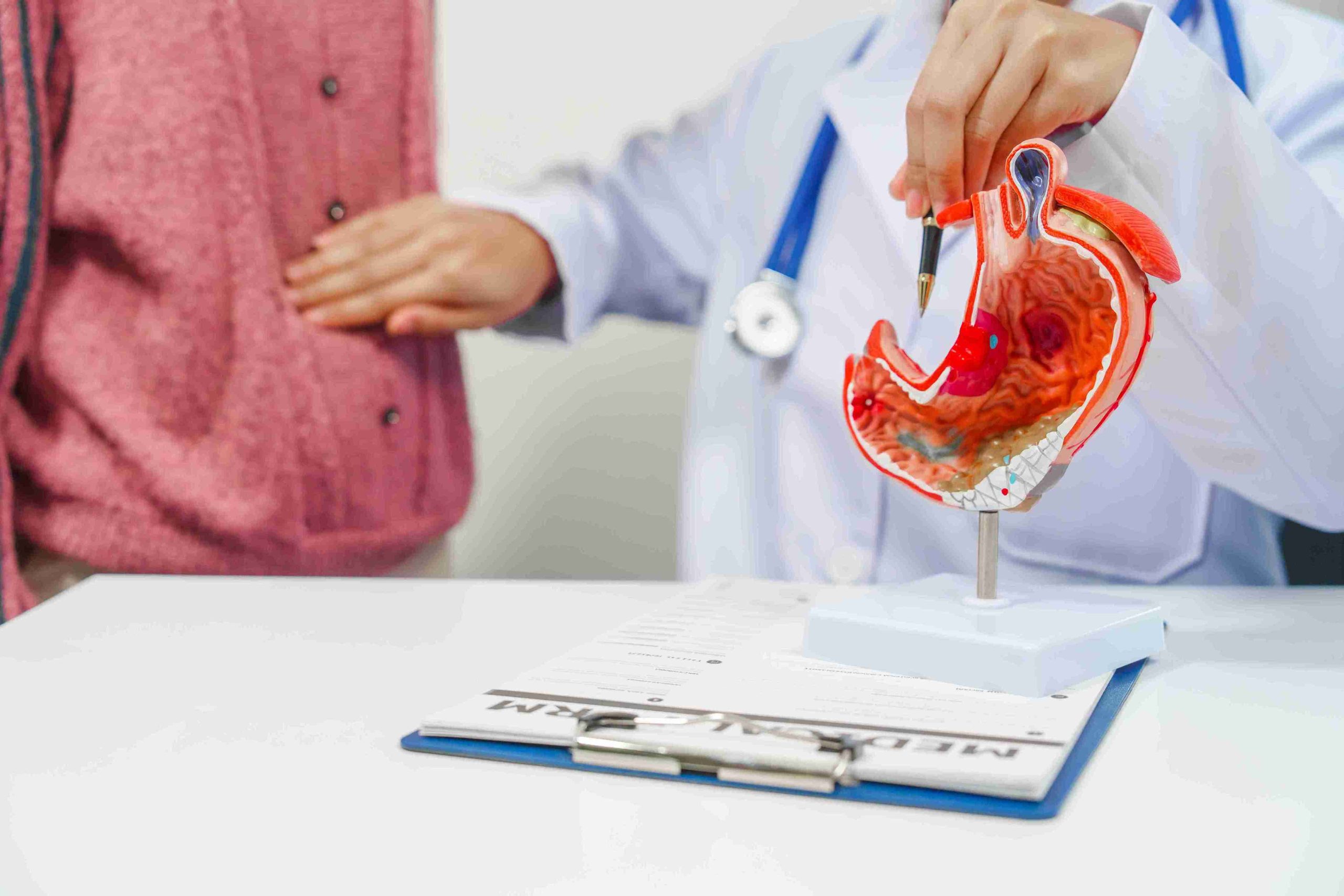 doctor speaking with a patient regarding gastric pain