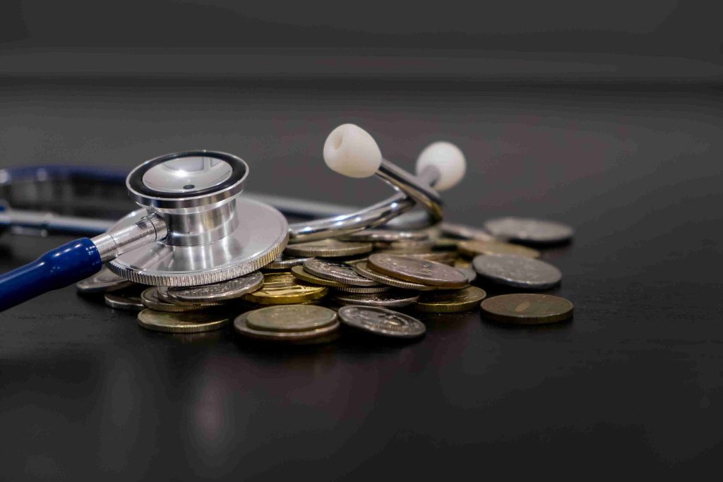 picture of a stethoscope and some coins