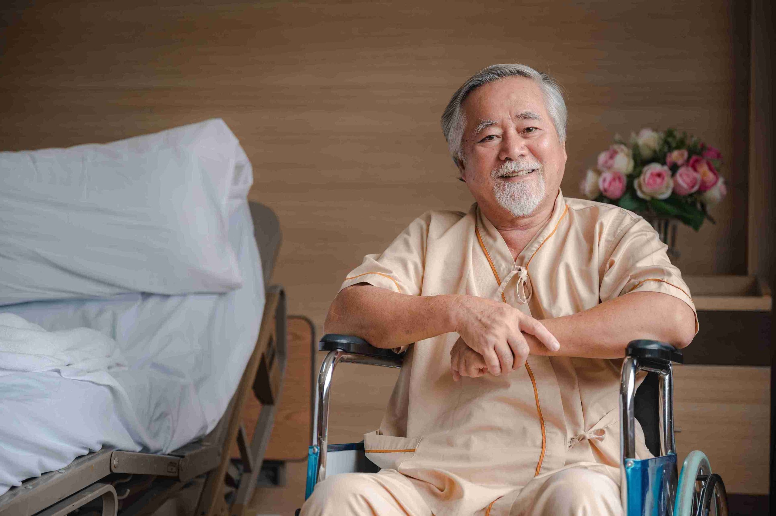 elderly patient sitting in a wheelchair smiling