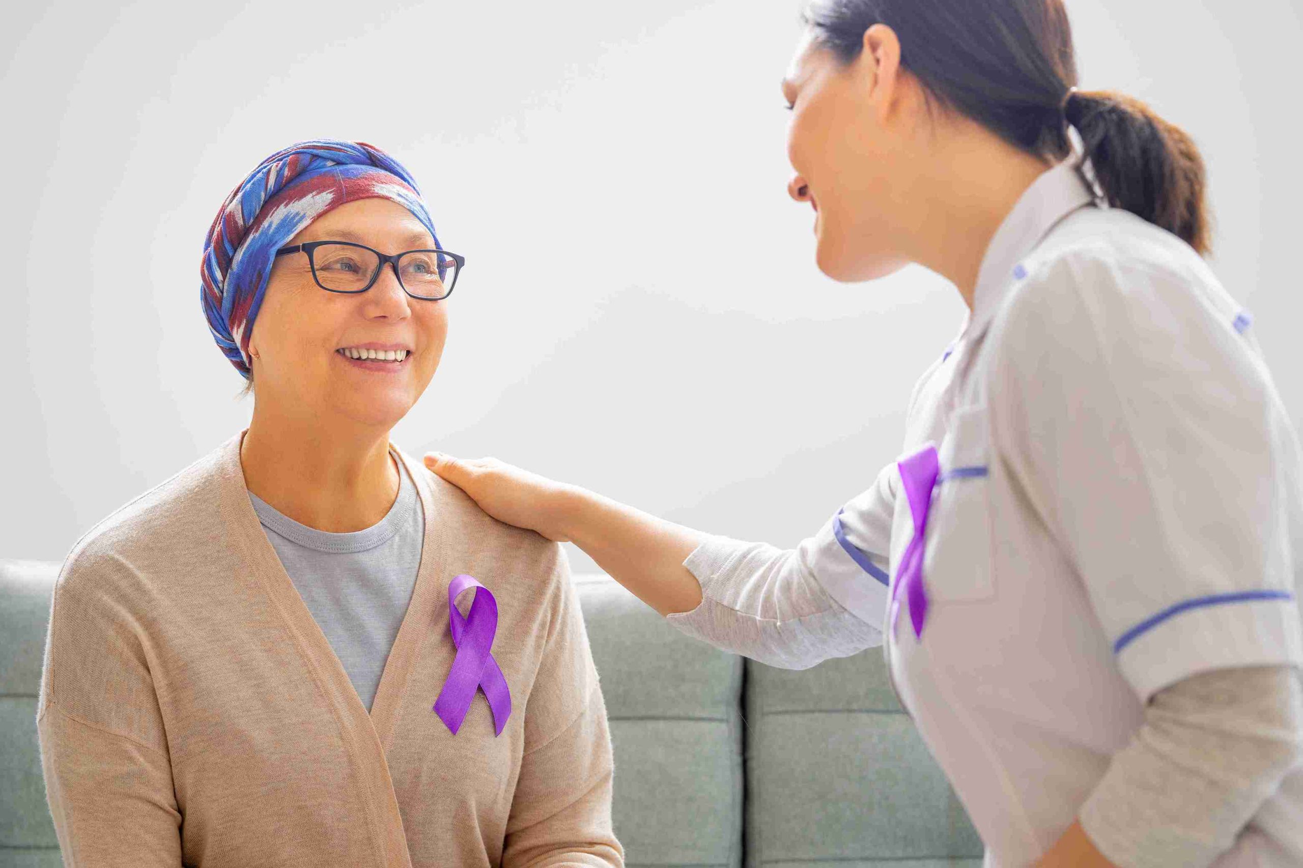 cancer patient smiling while speaking with healthcare worker
