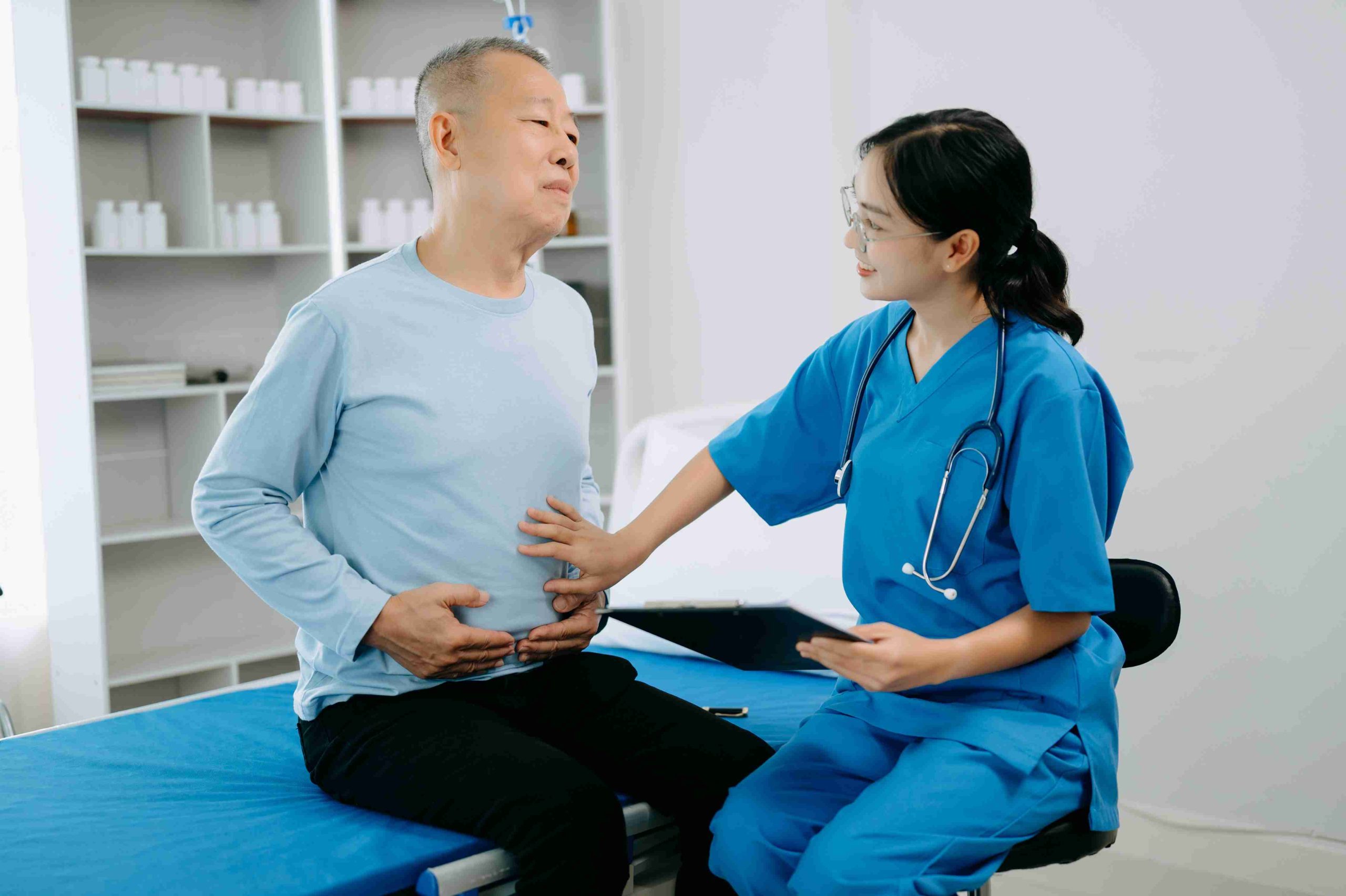 doctor speaking with patient with stomach pain