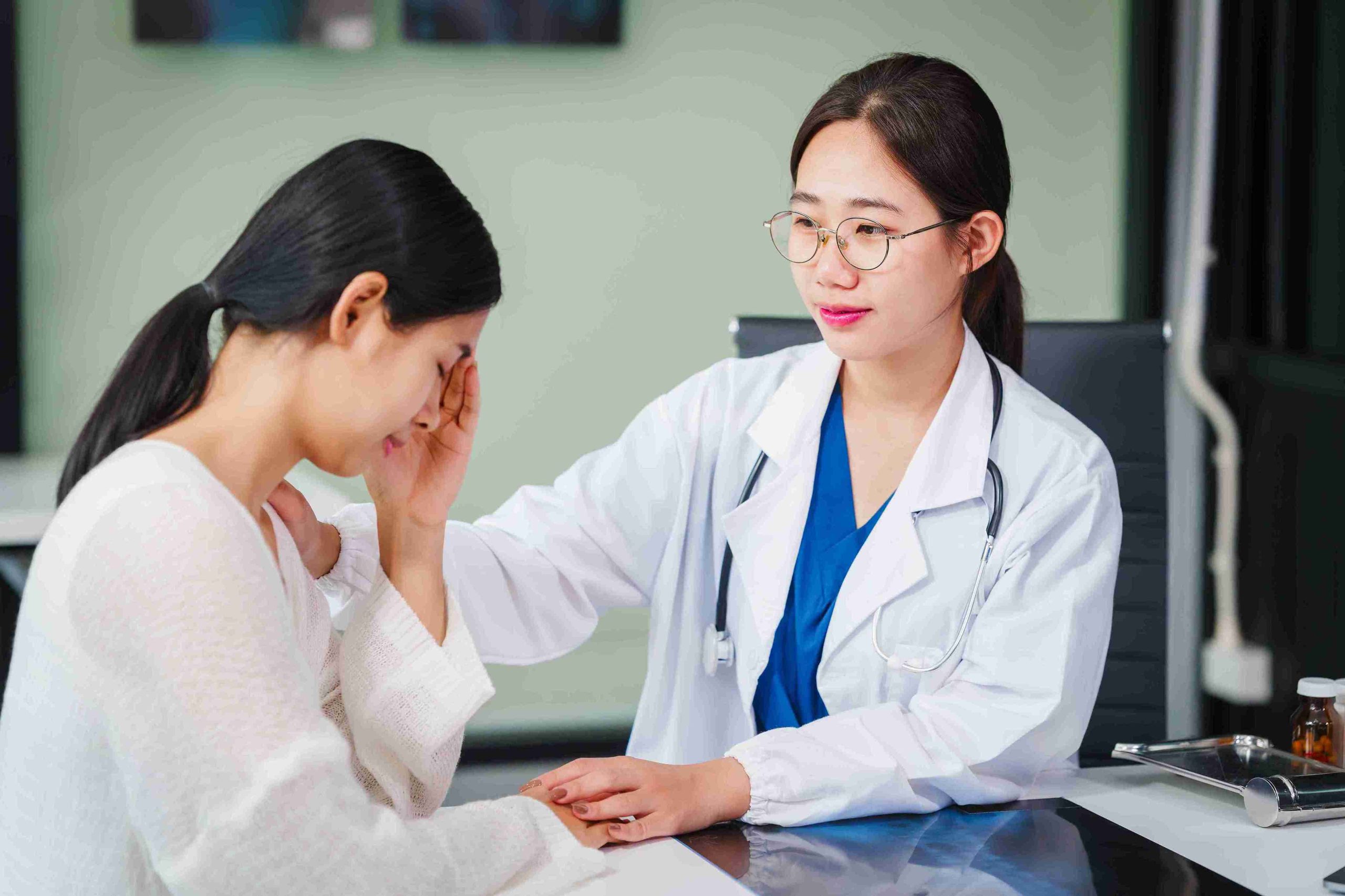 young female doctor comforting a female patient