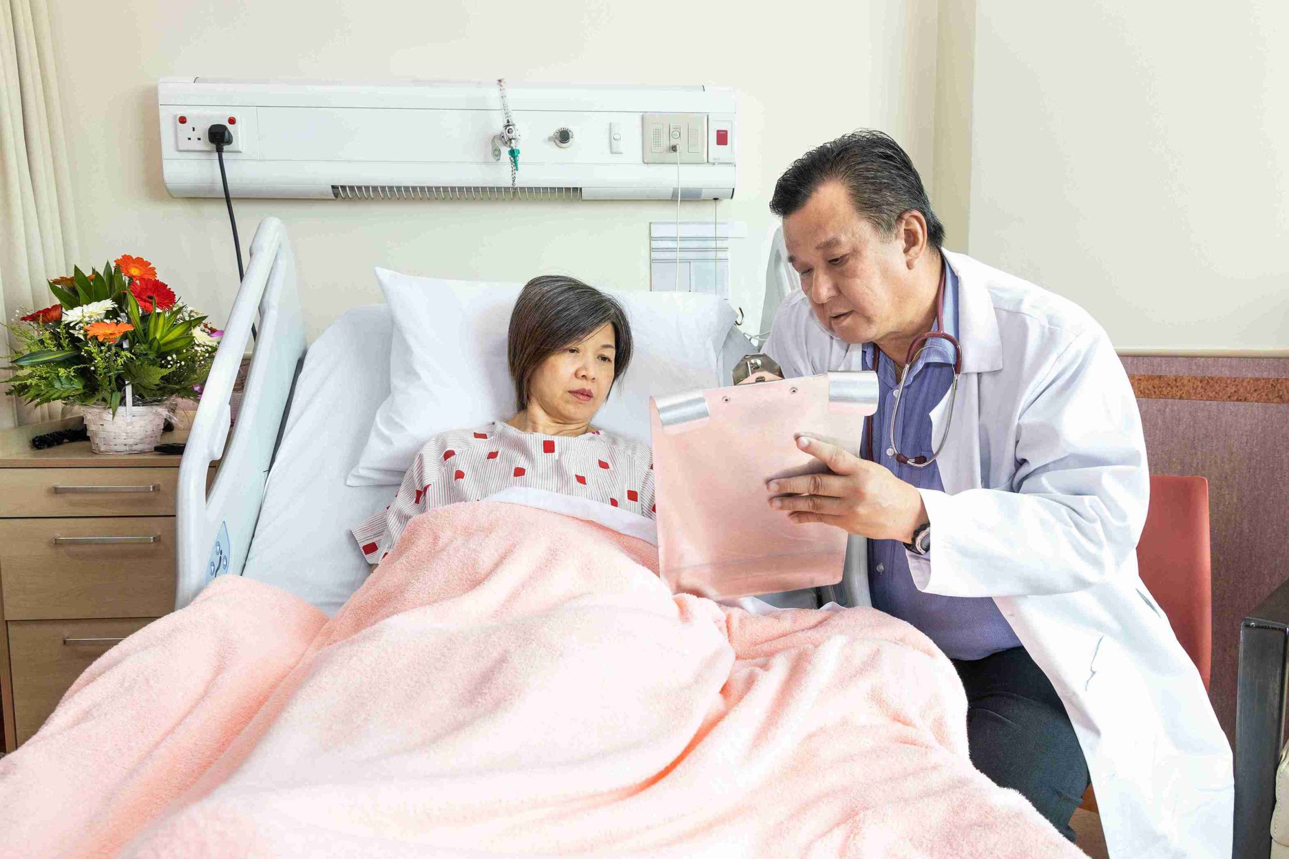 doctor explaining results to a patient lying in bed