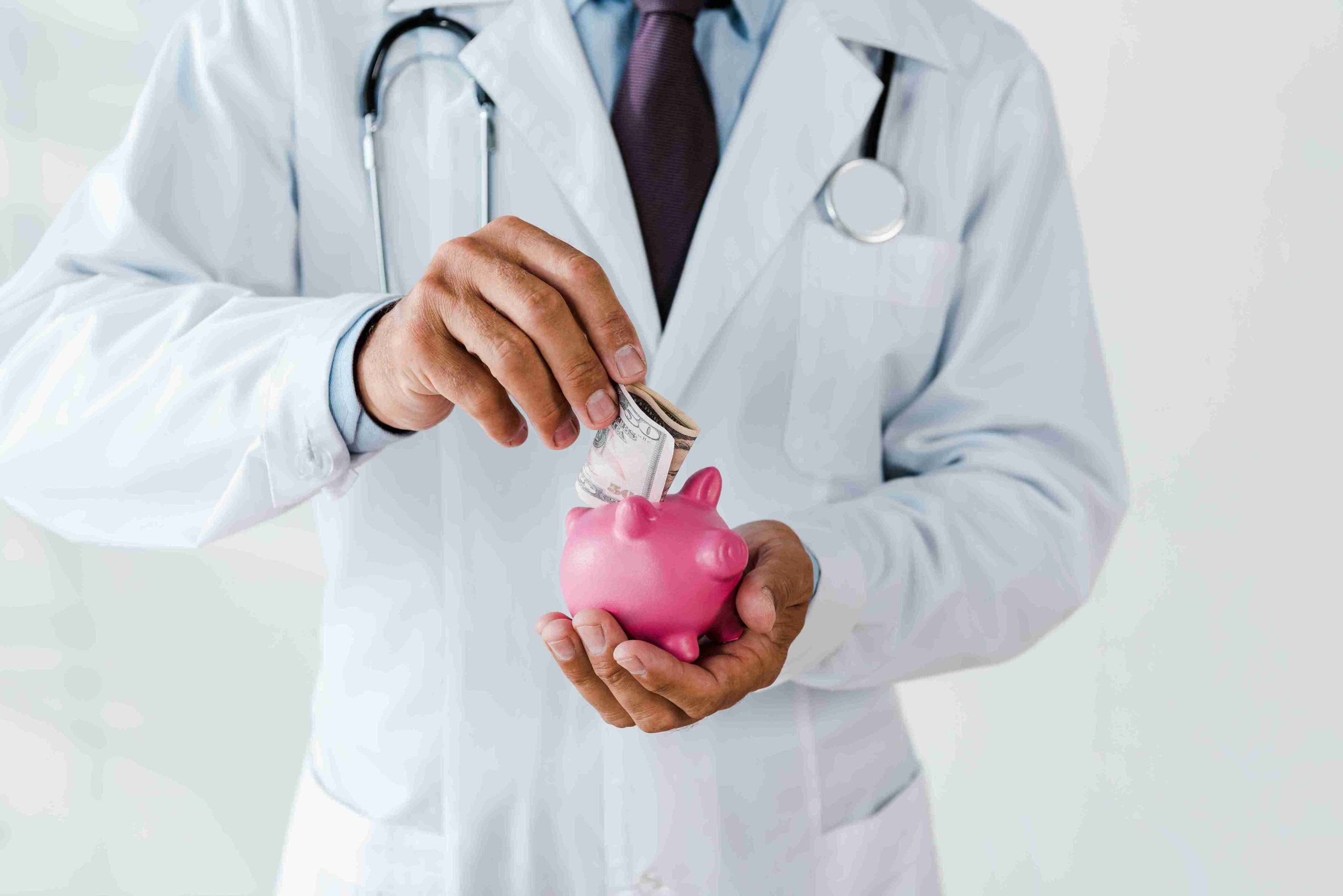 doctor putting money in a piggy bank