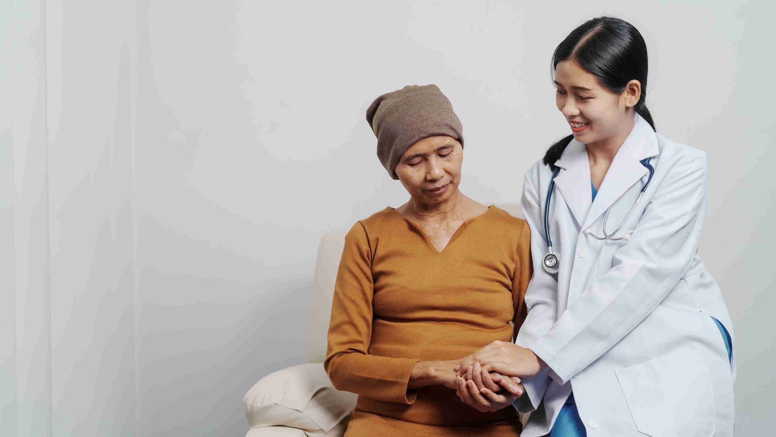 elderly cancer patient comforted by a doctor