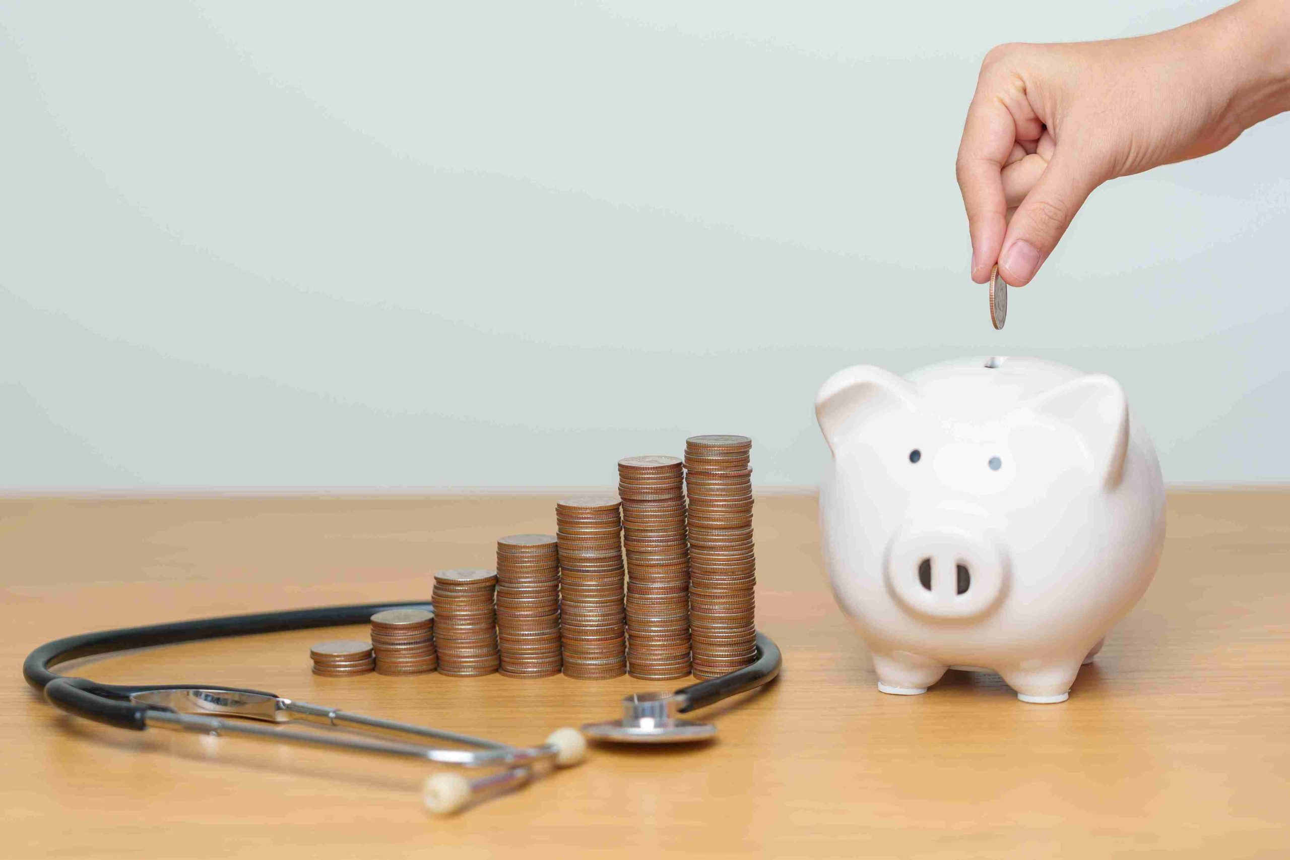 patient depositing coins in a piggy bank for medical expenses