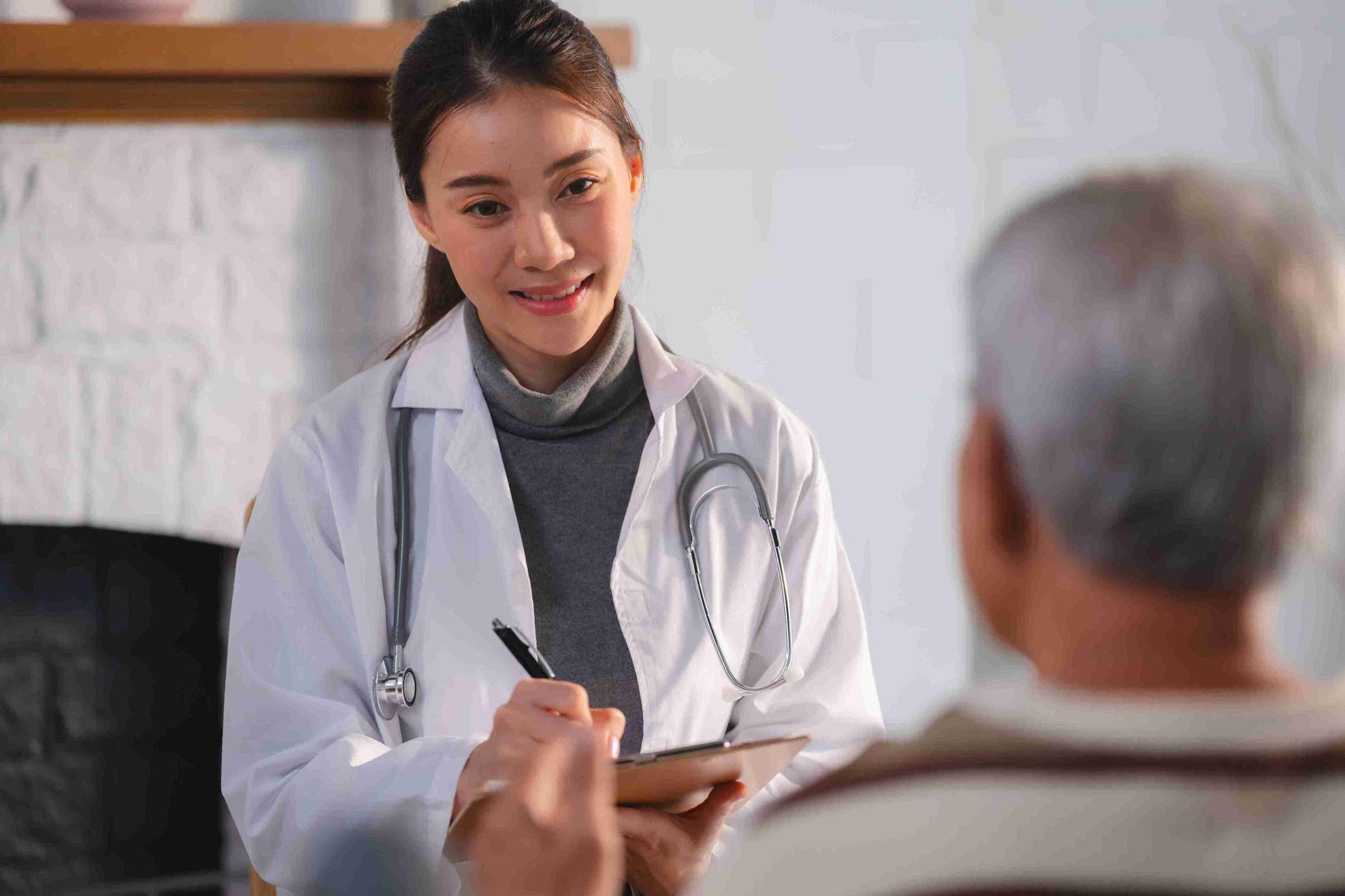 young female doctor speaking with an elderly patient