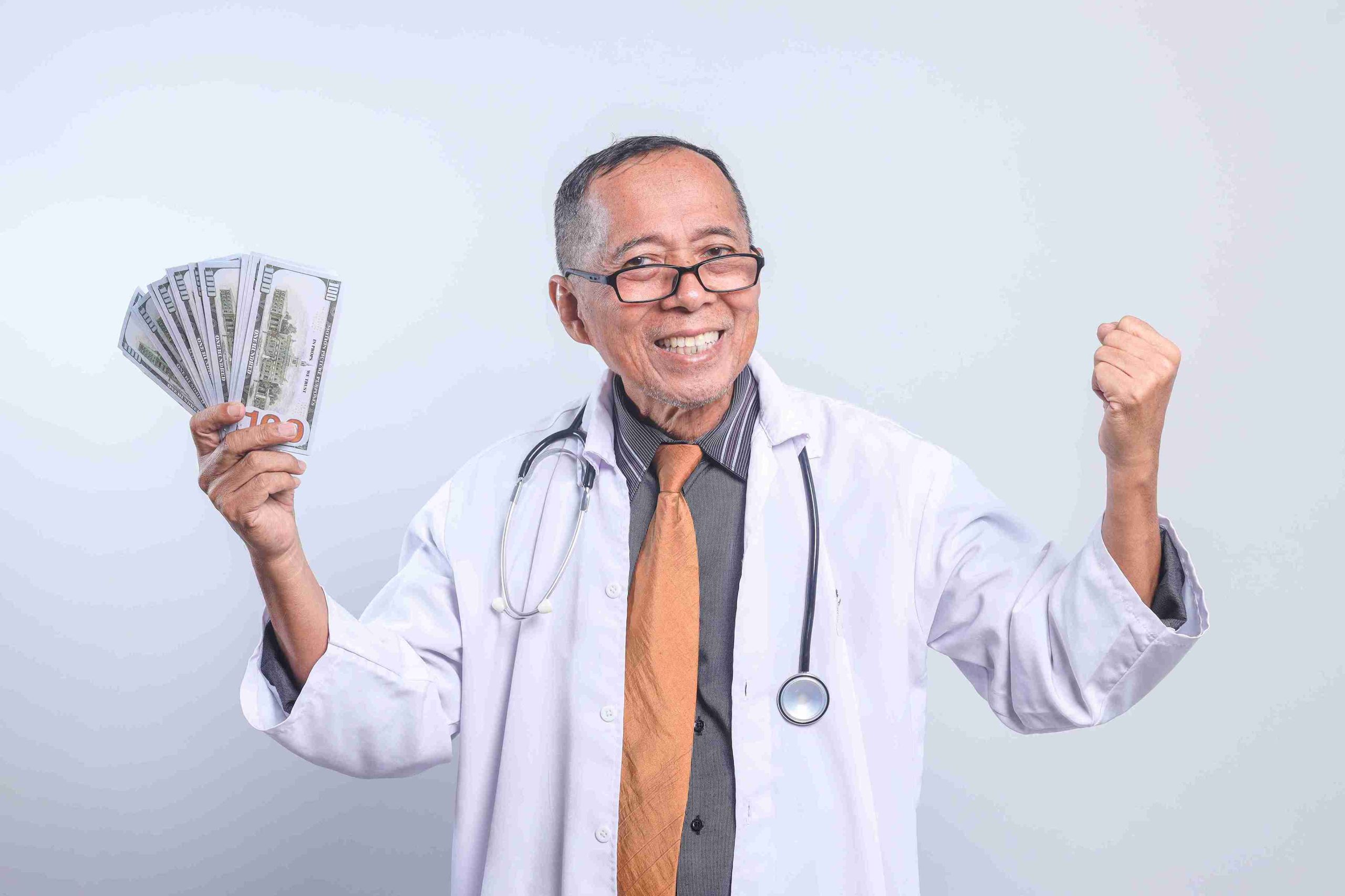 doctor holding money and smiling