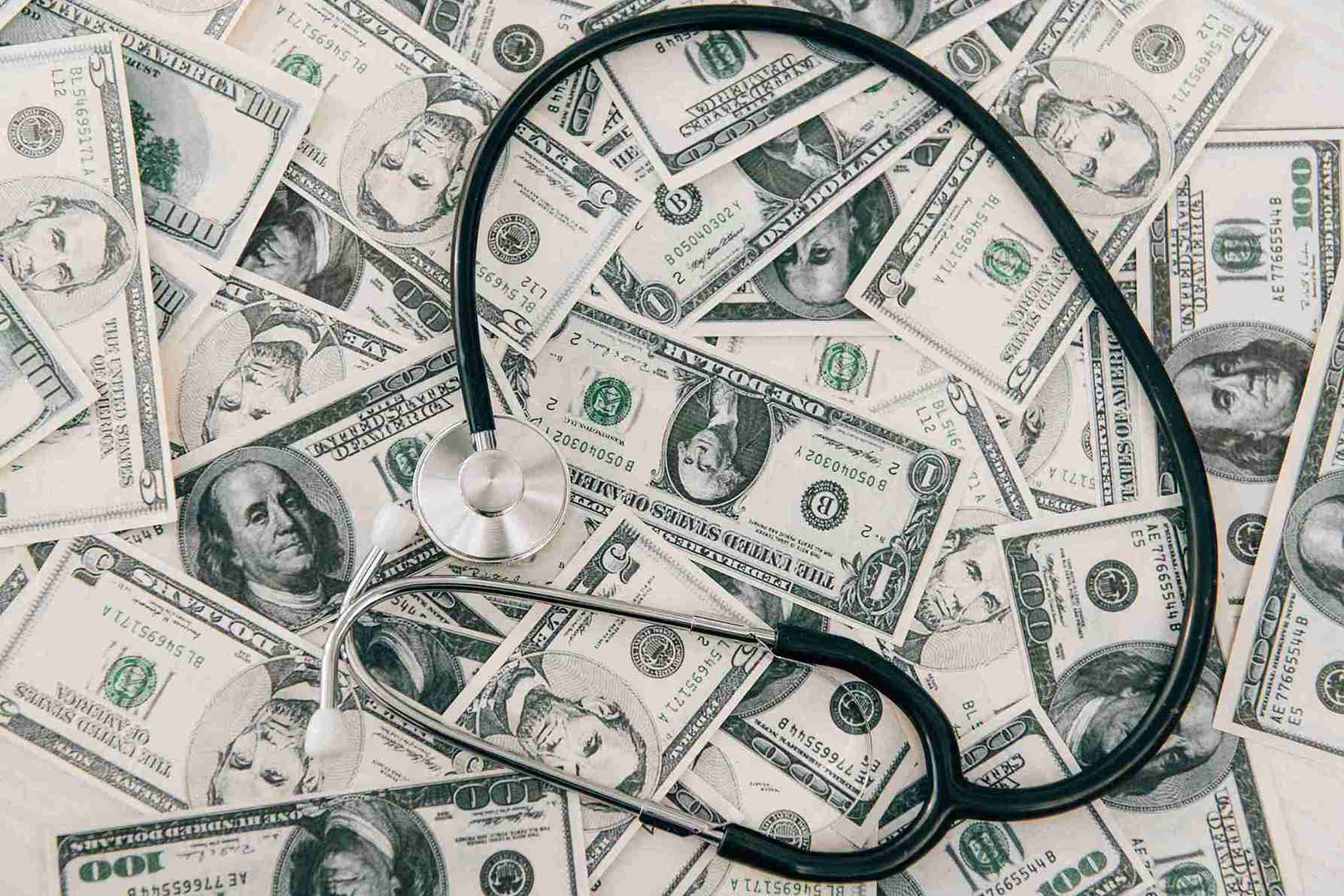 stethoscope on top of dollar bills
