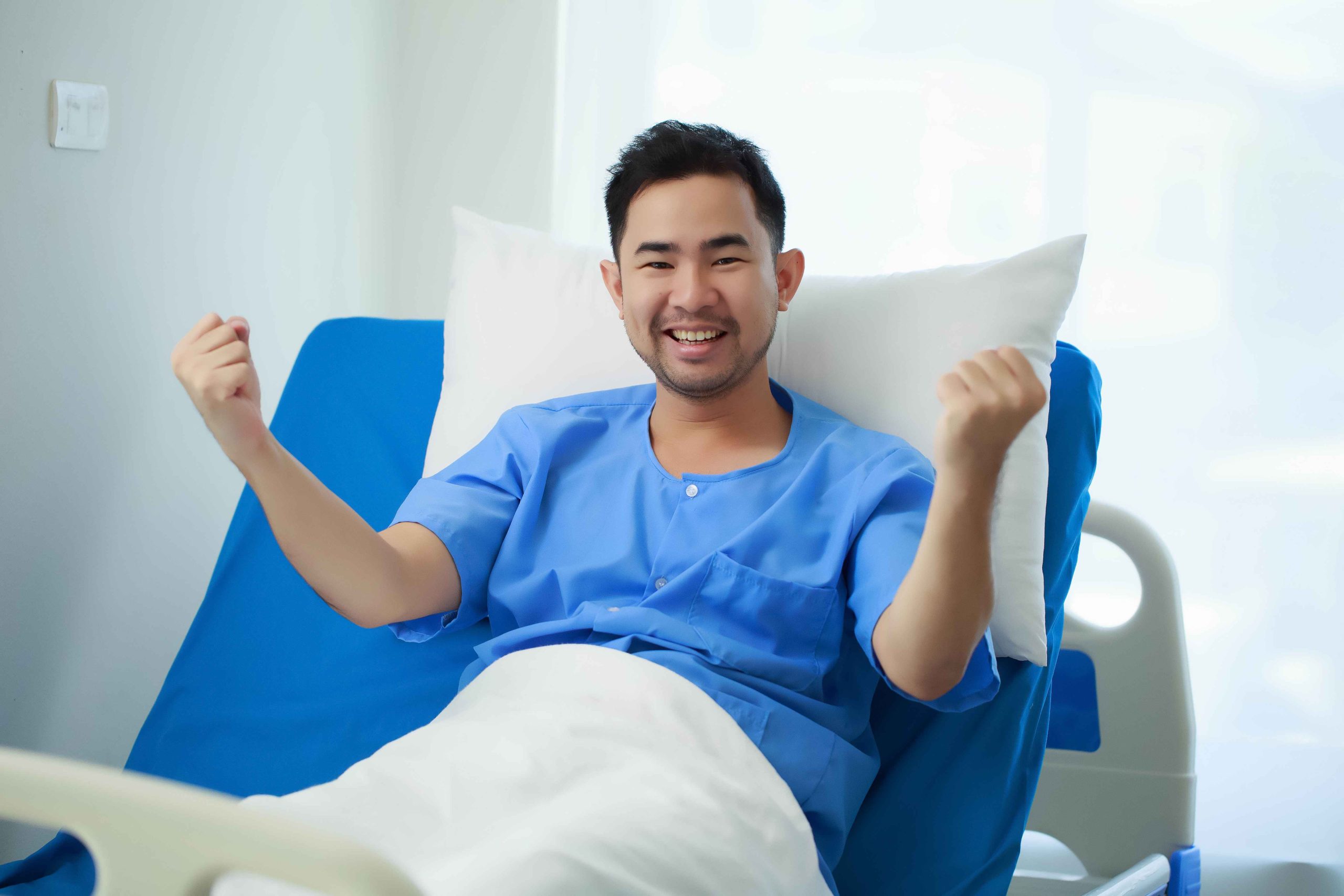 male patient sitting in the hospital bed recovering