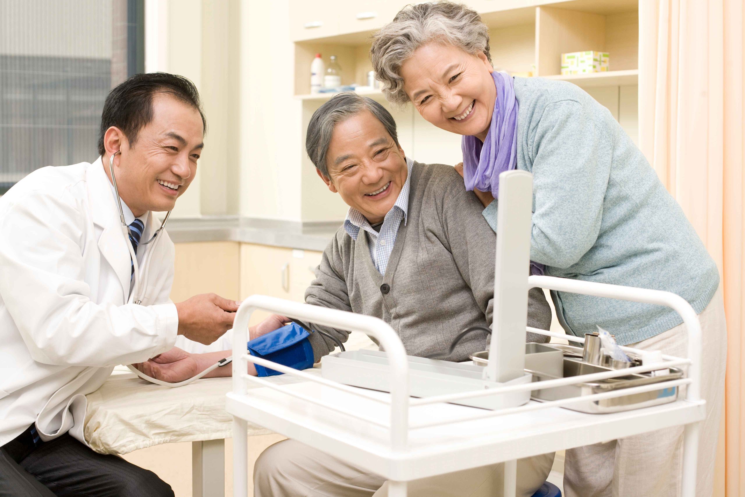 doctor checking the vitals of his elderly patient