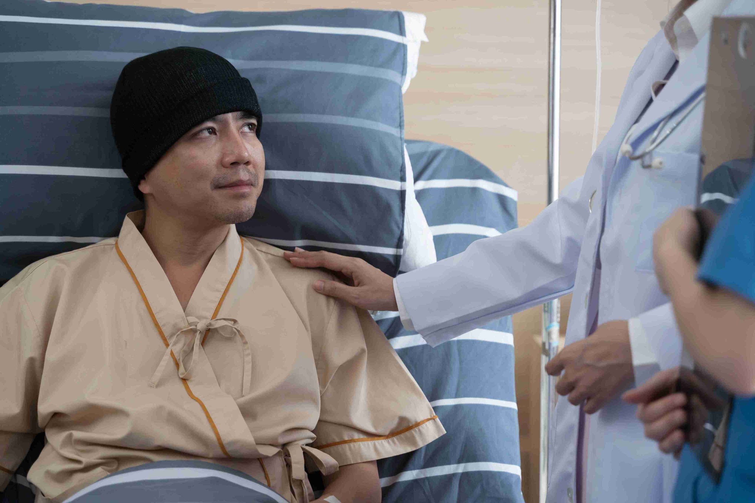 male cancer patient speaking with his doctor