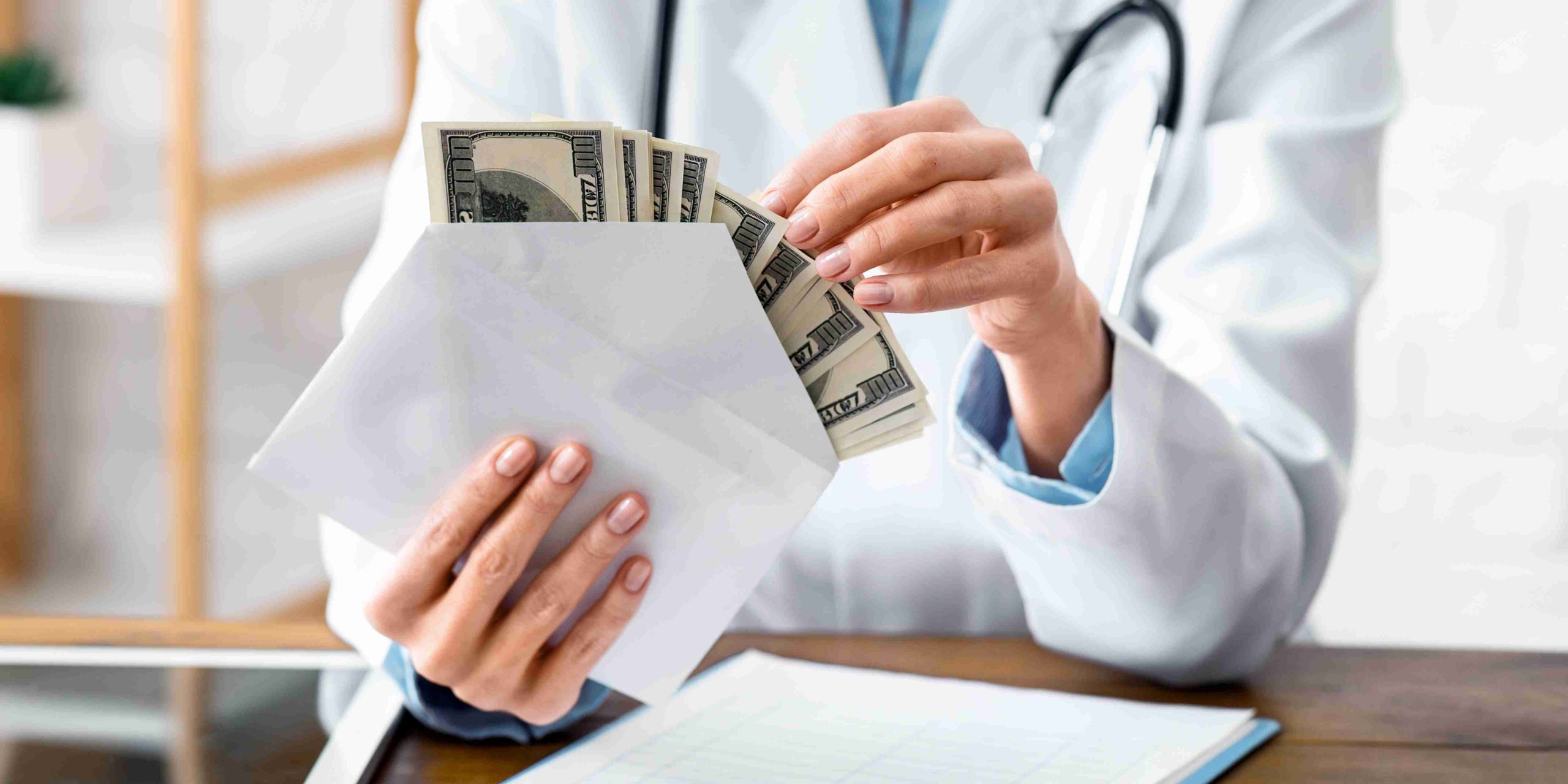 healthcare worker counting money in an envelope