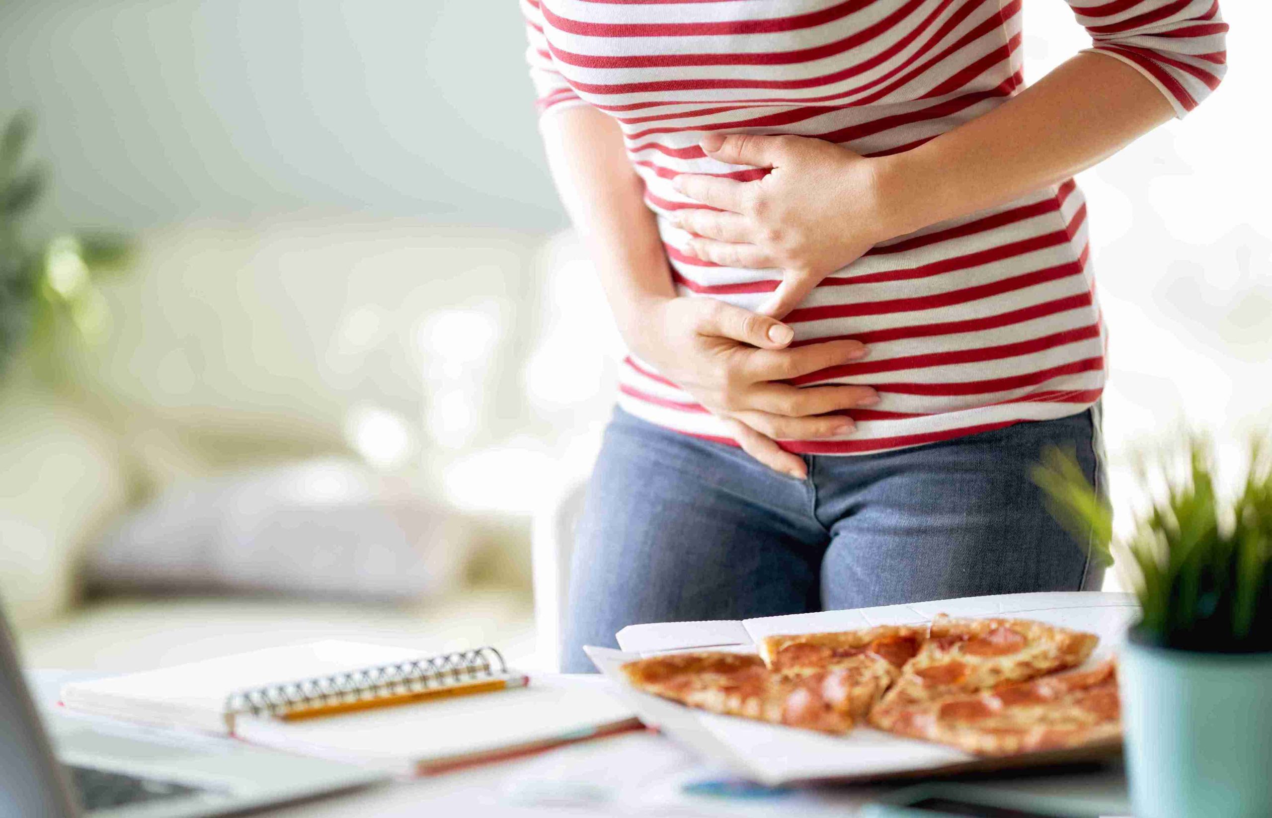 woman with abdominal pain while eating
