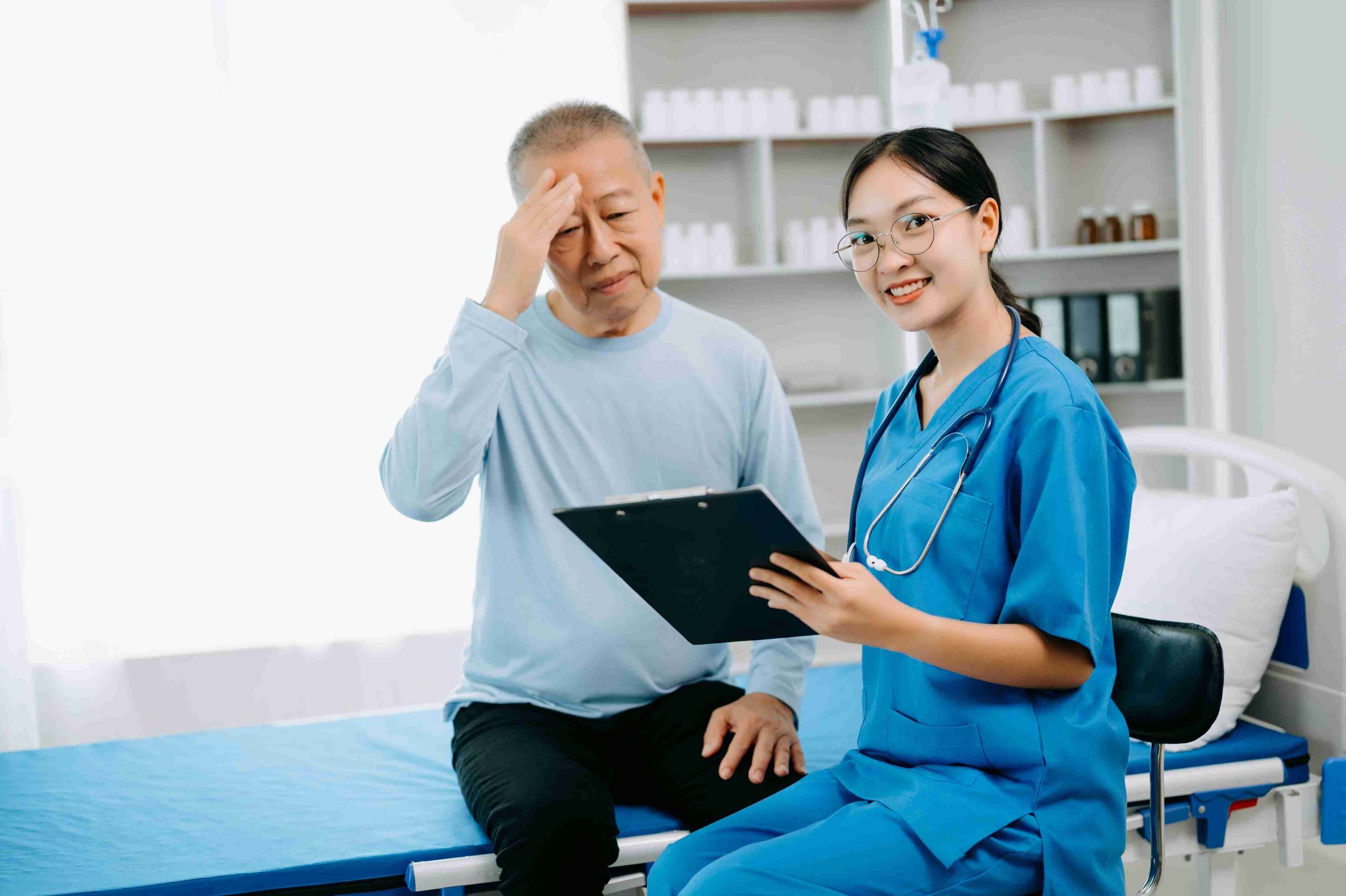 elderly patient speaking with his doctor in hospital bed