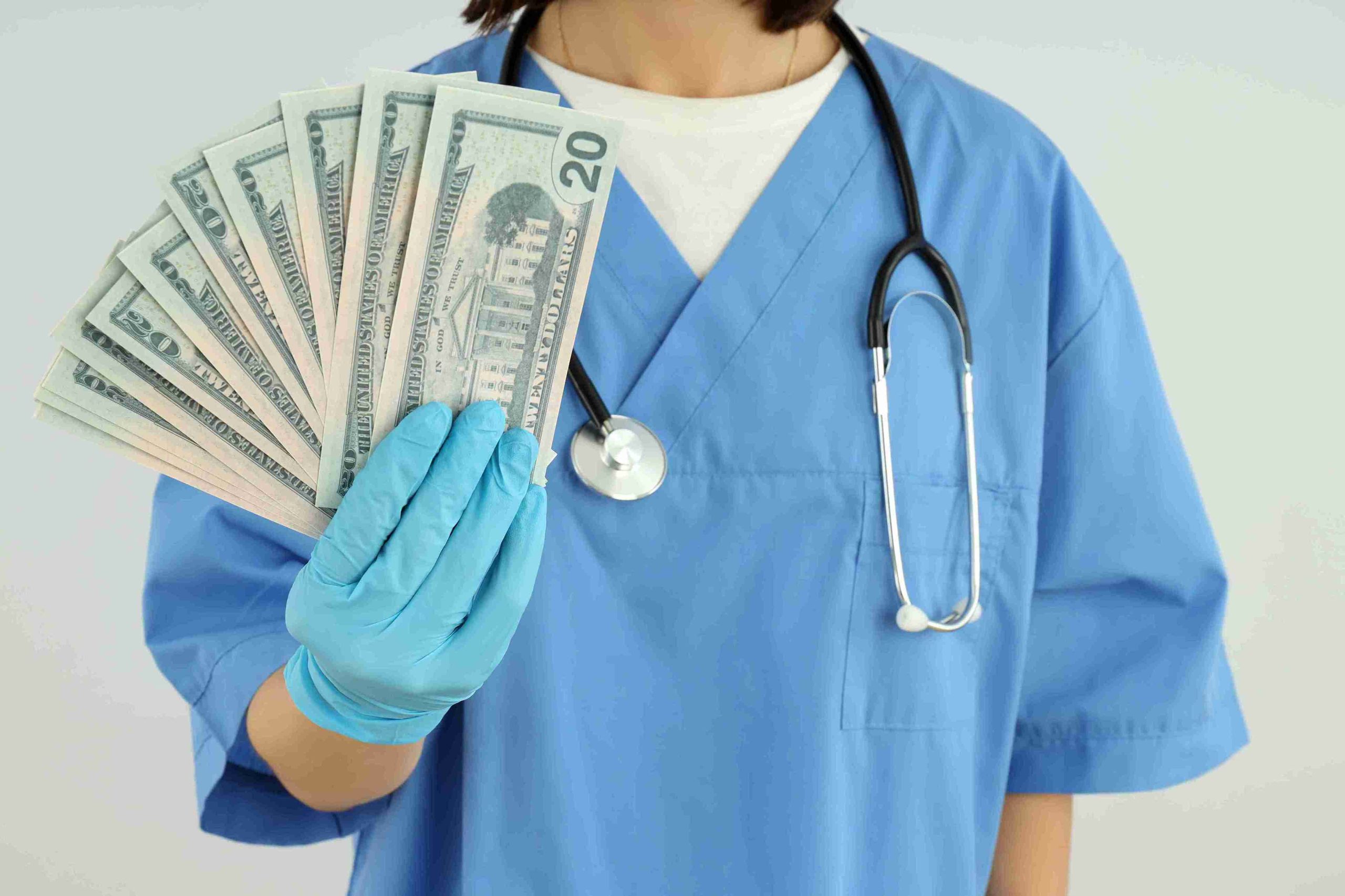 healthcare worker holding money