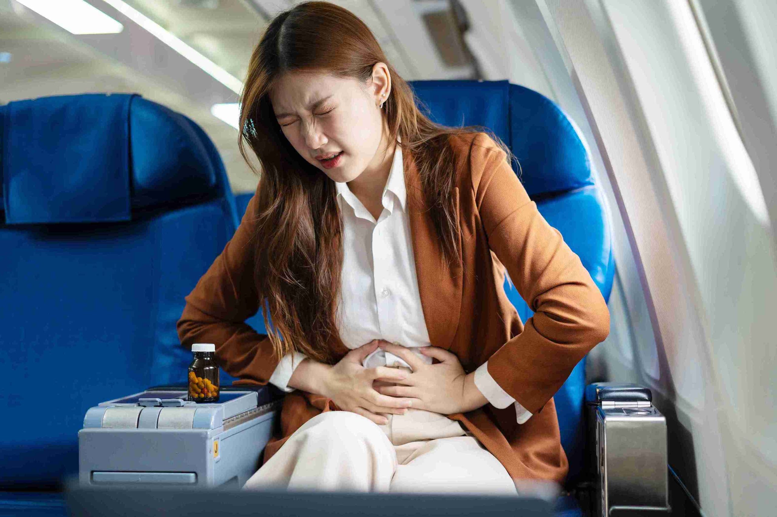 woman sitting with excruciating stomach pain
