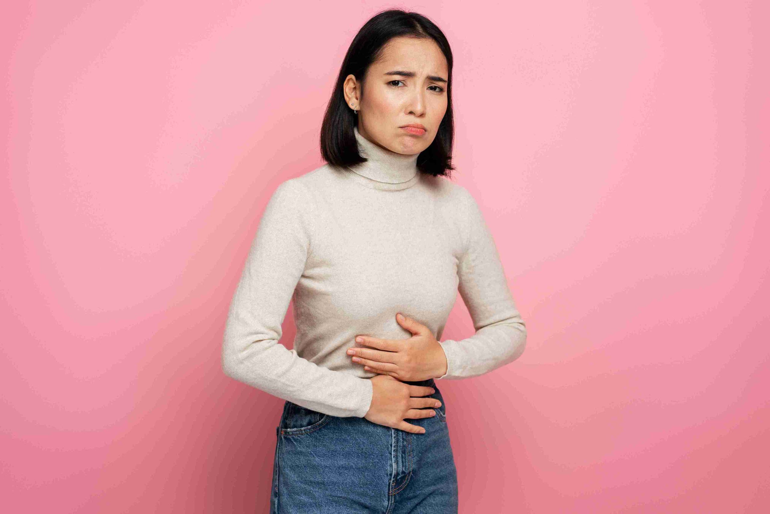 woman standing with her hands on her stomach