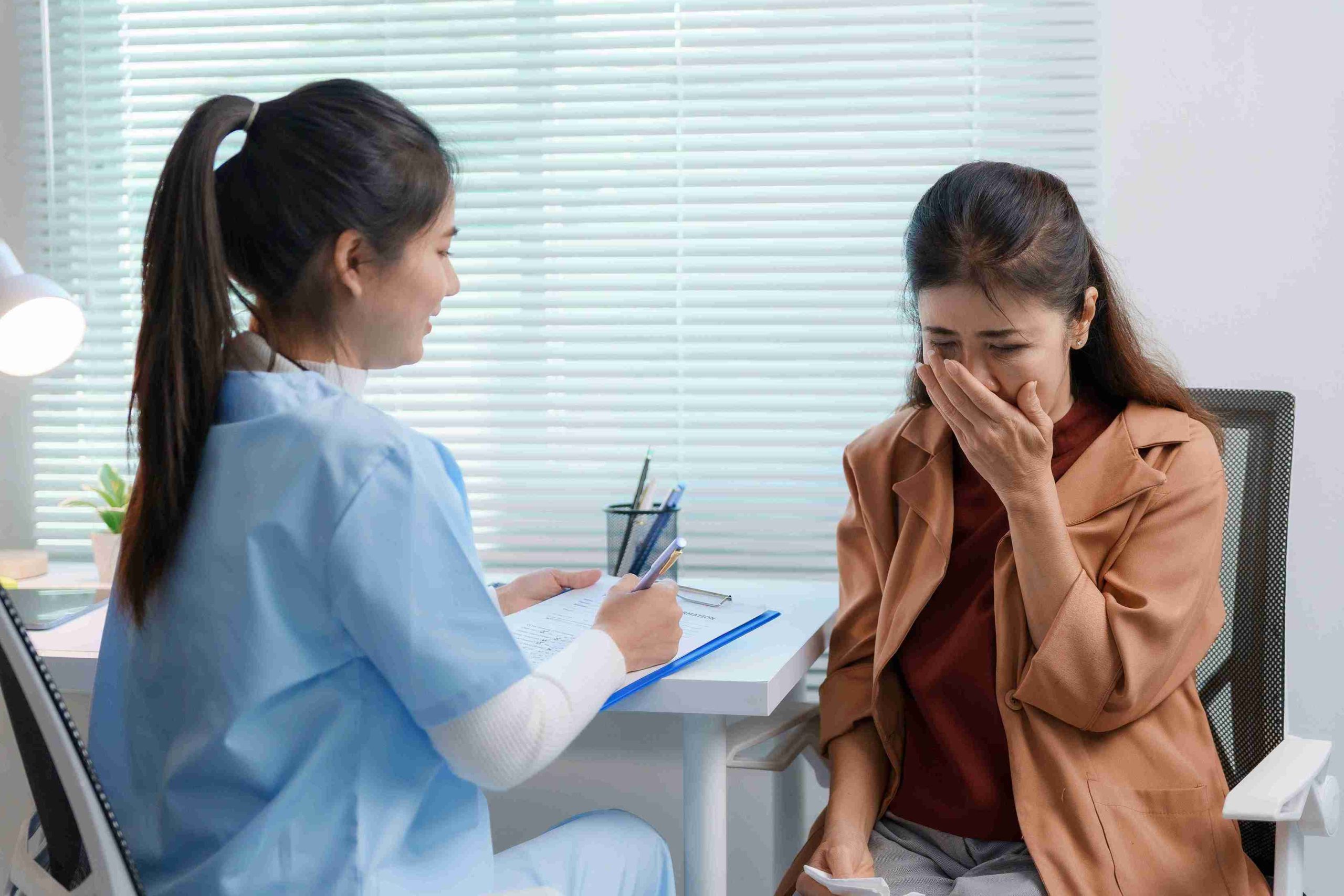 patient having swallowing difficulty speaking with her doctor