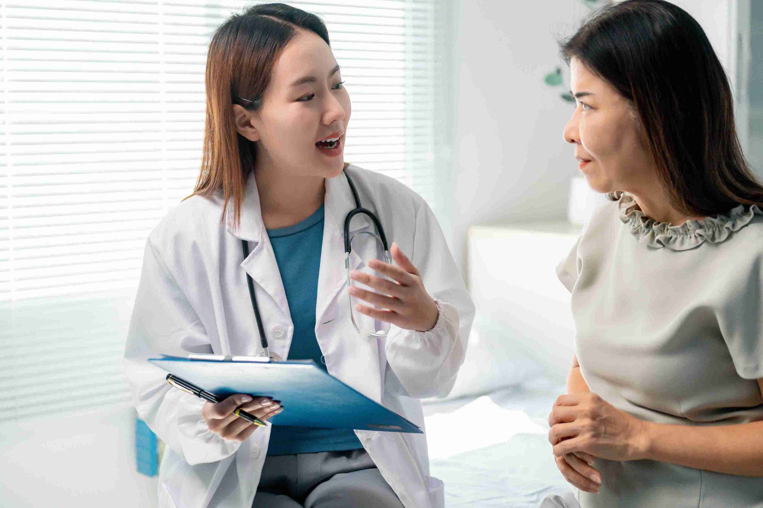 doctor speaking with her elderly patient