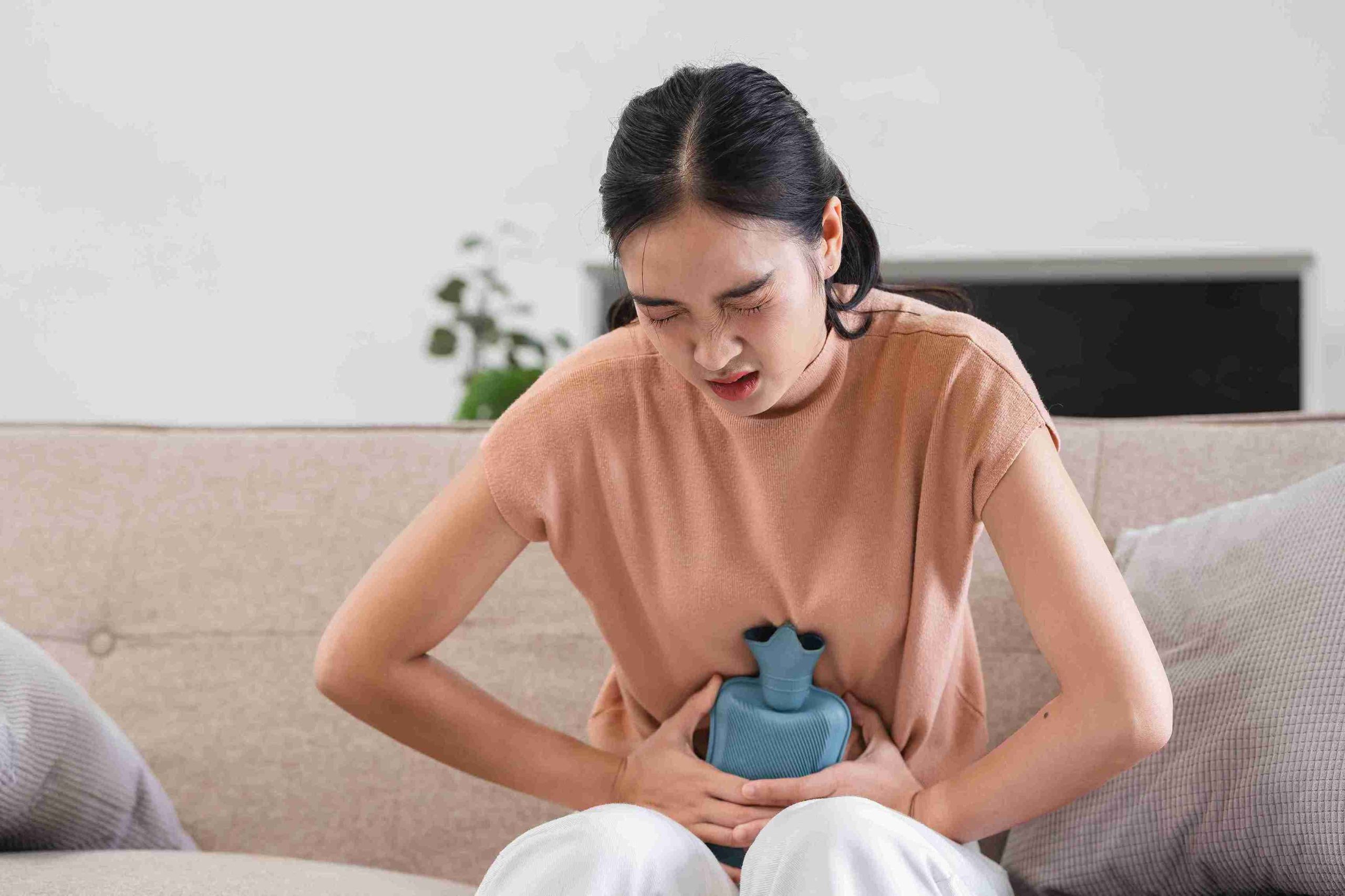 woman sitting with a painful stomach