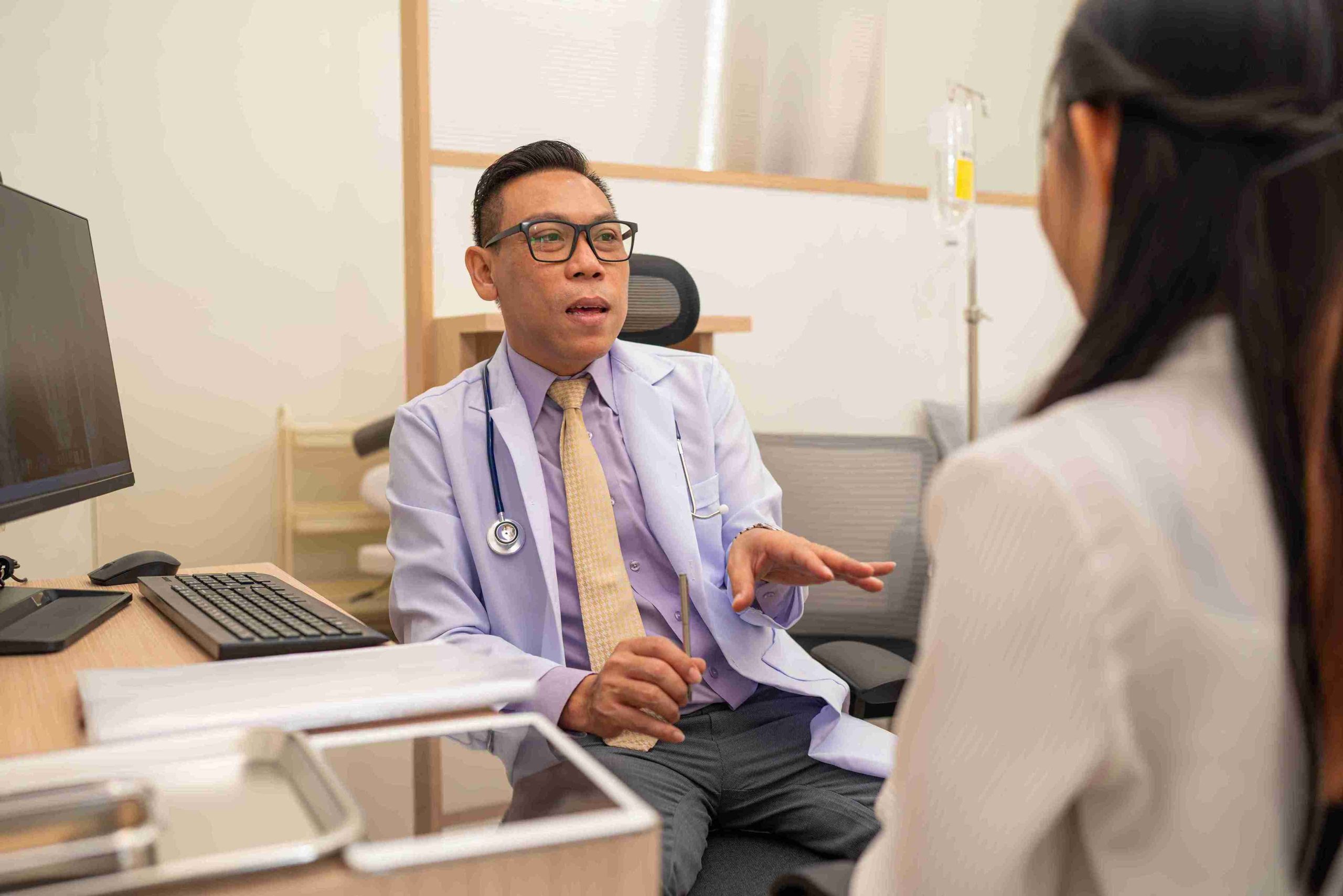 Doctor explaining to patient about colonoscopy costs.