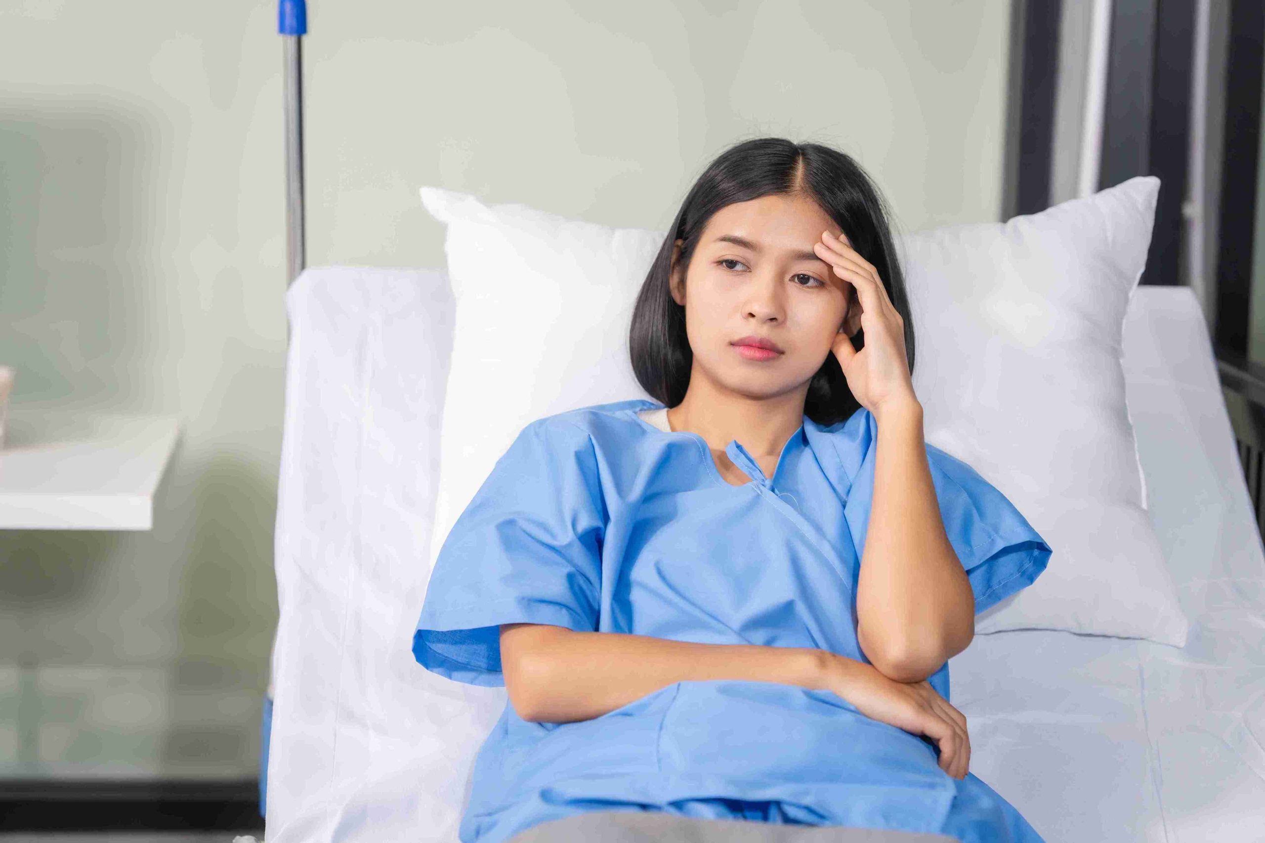 Female patient sitting in the hospital bed.