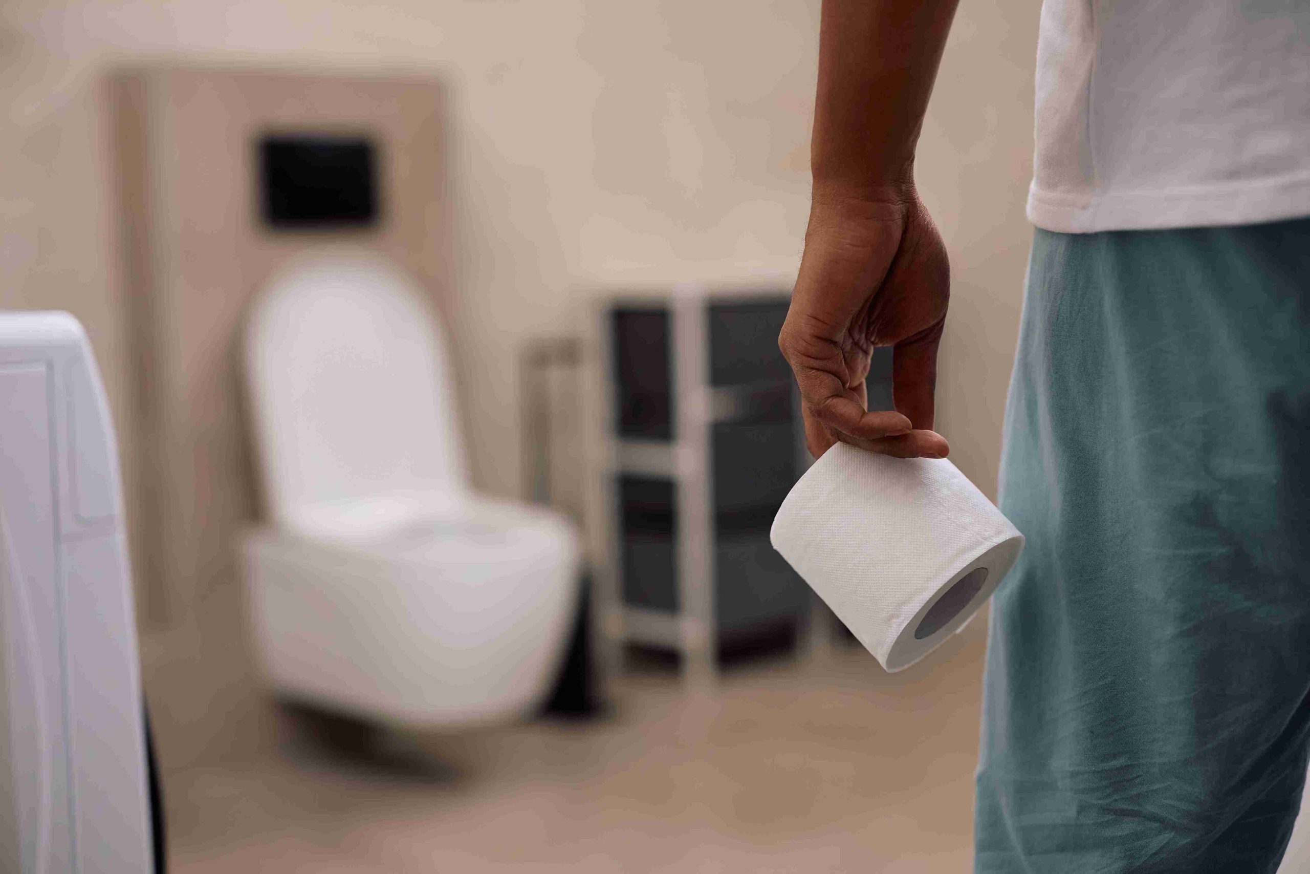 Man holding a toilet paper.