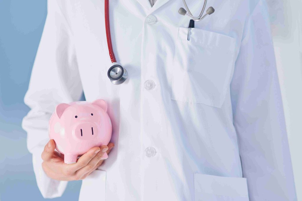 A healthcare worker carrying a piggy bank.