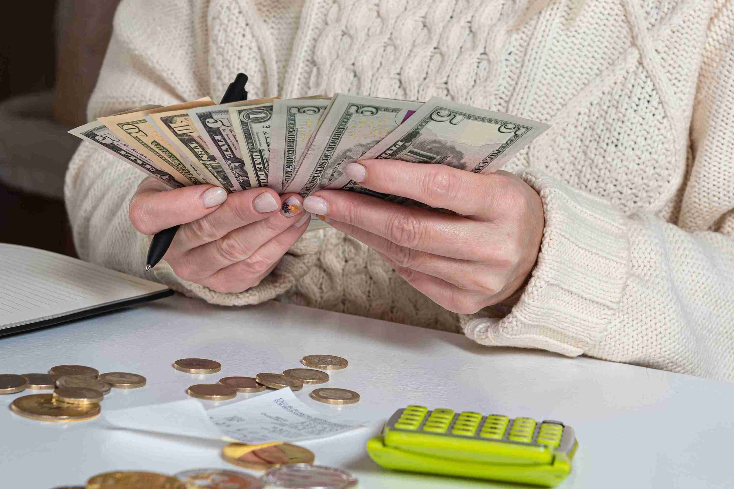 Woman counting dollar bills.
