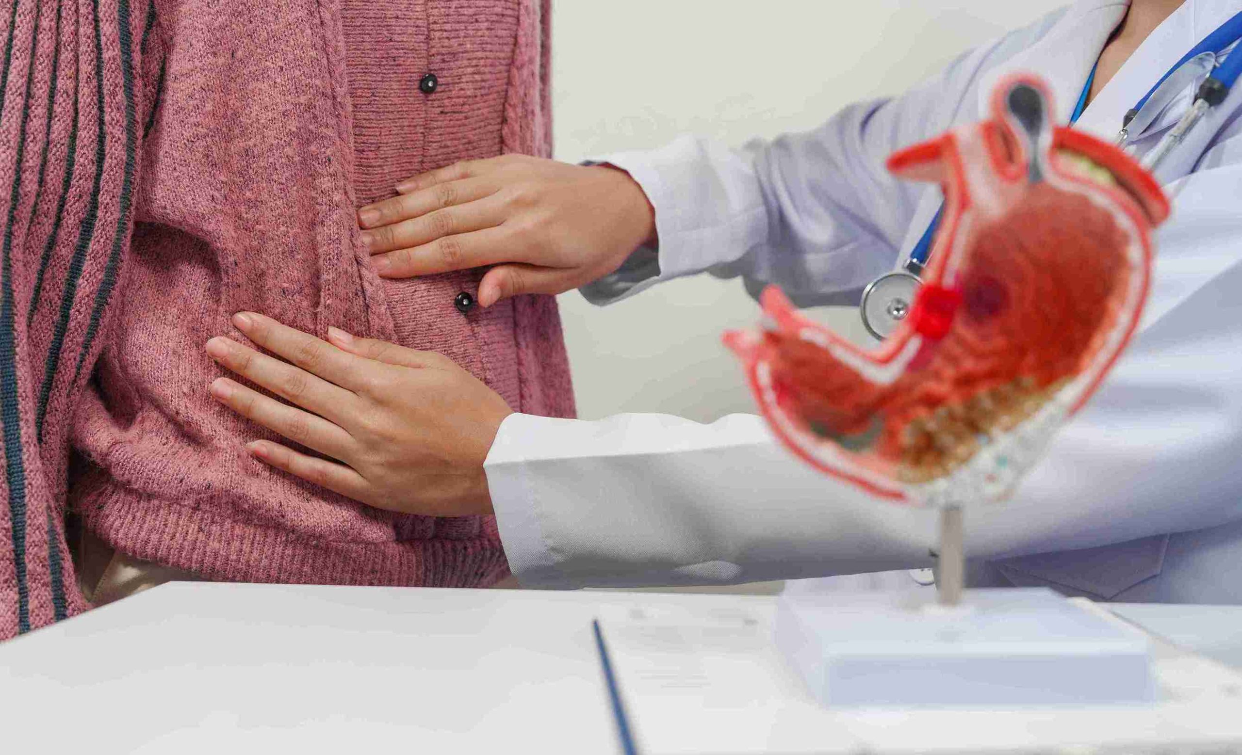 Doctor examining a patient with gastric pain.