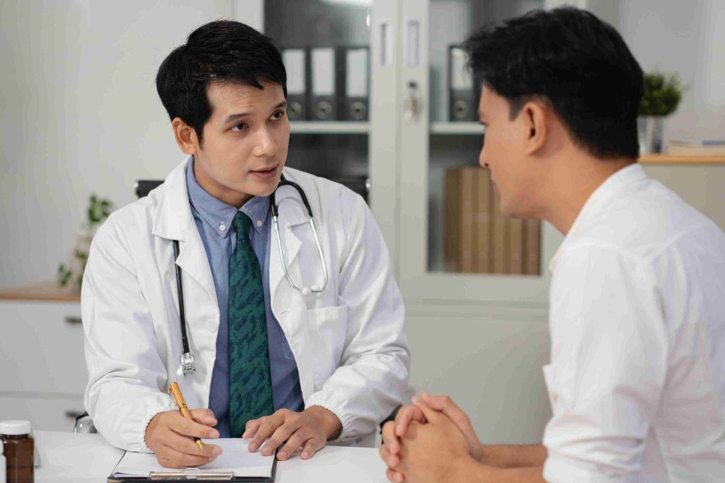 Doctor explaining something to a male patient.