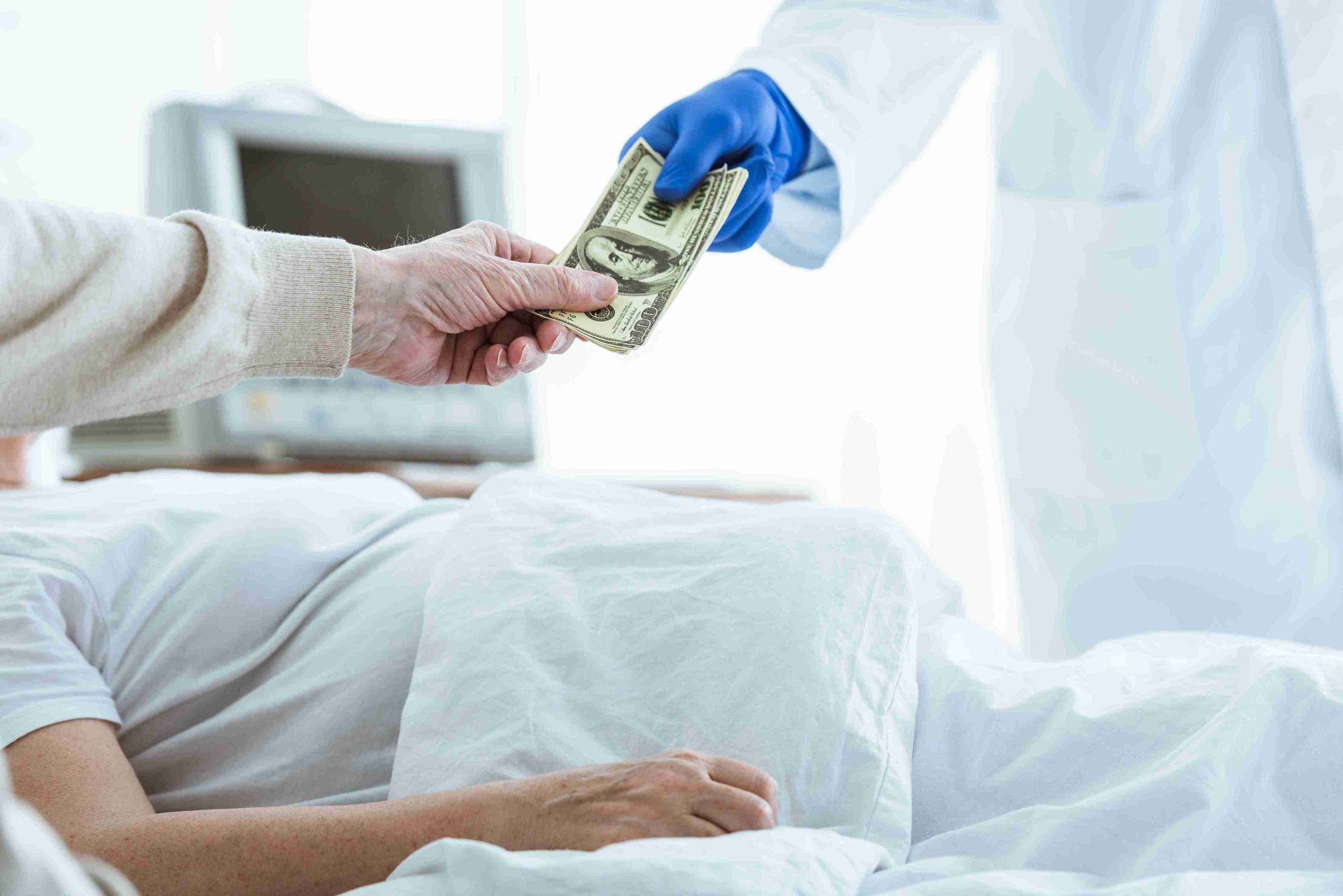 Kin of patient handing over money to doctor.