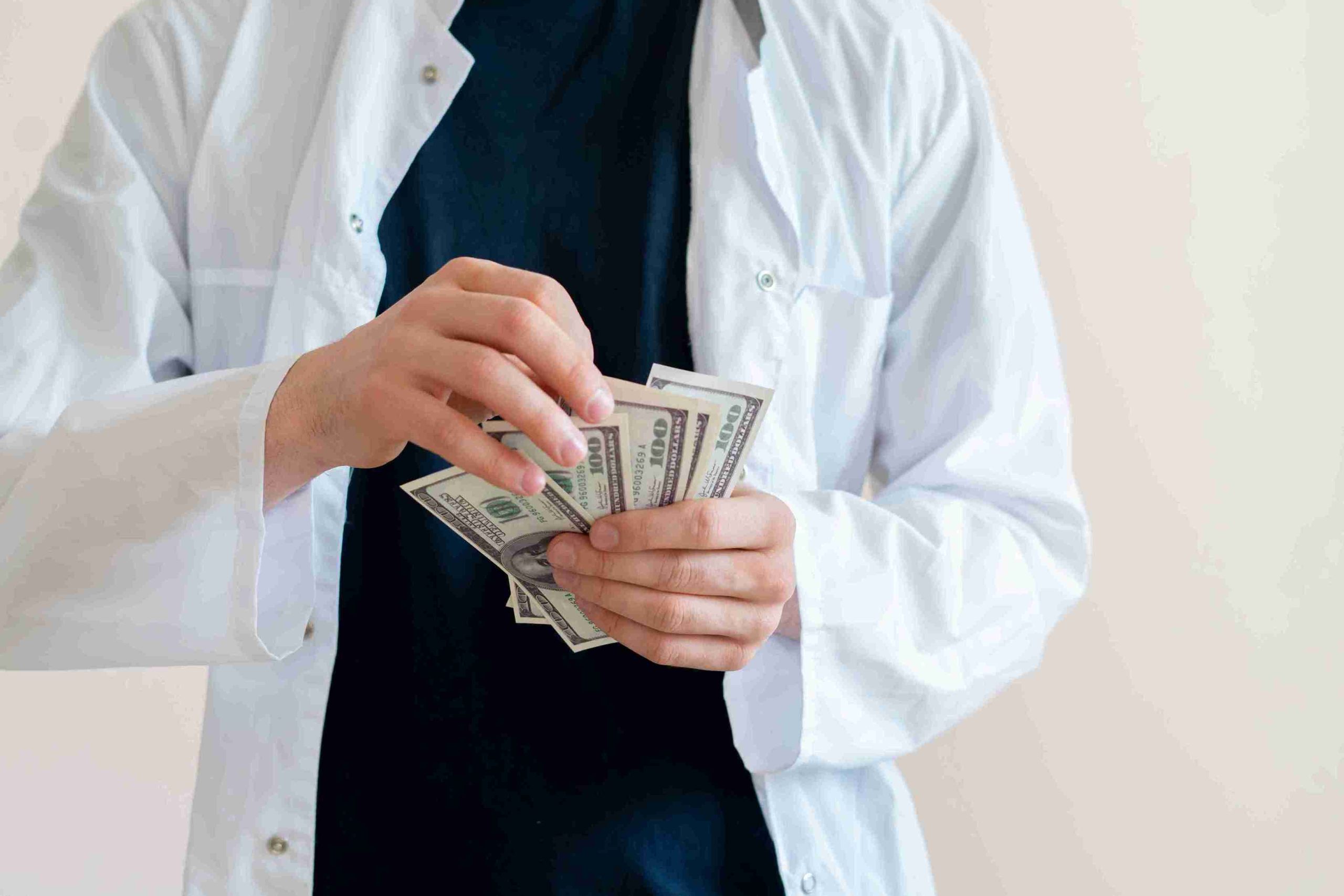 Image of a person holding dollar bills.