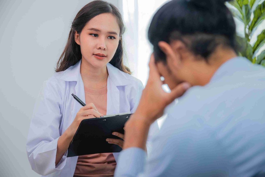 Young doctor speaking with her worried patient.