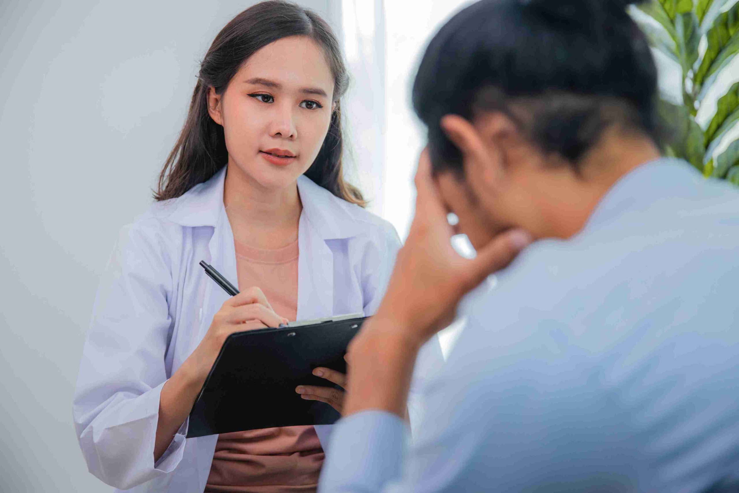 Young doctor speaking with her worried patient.