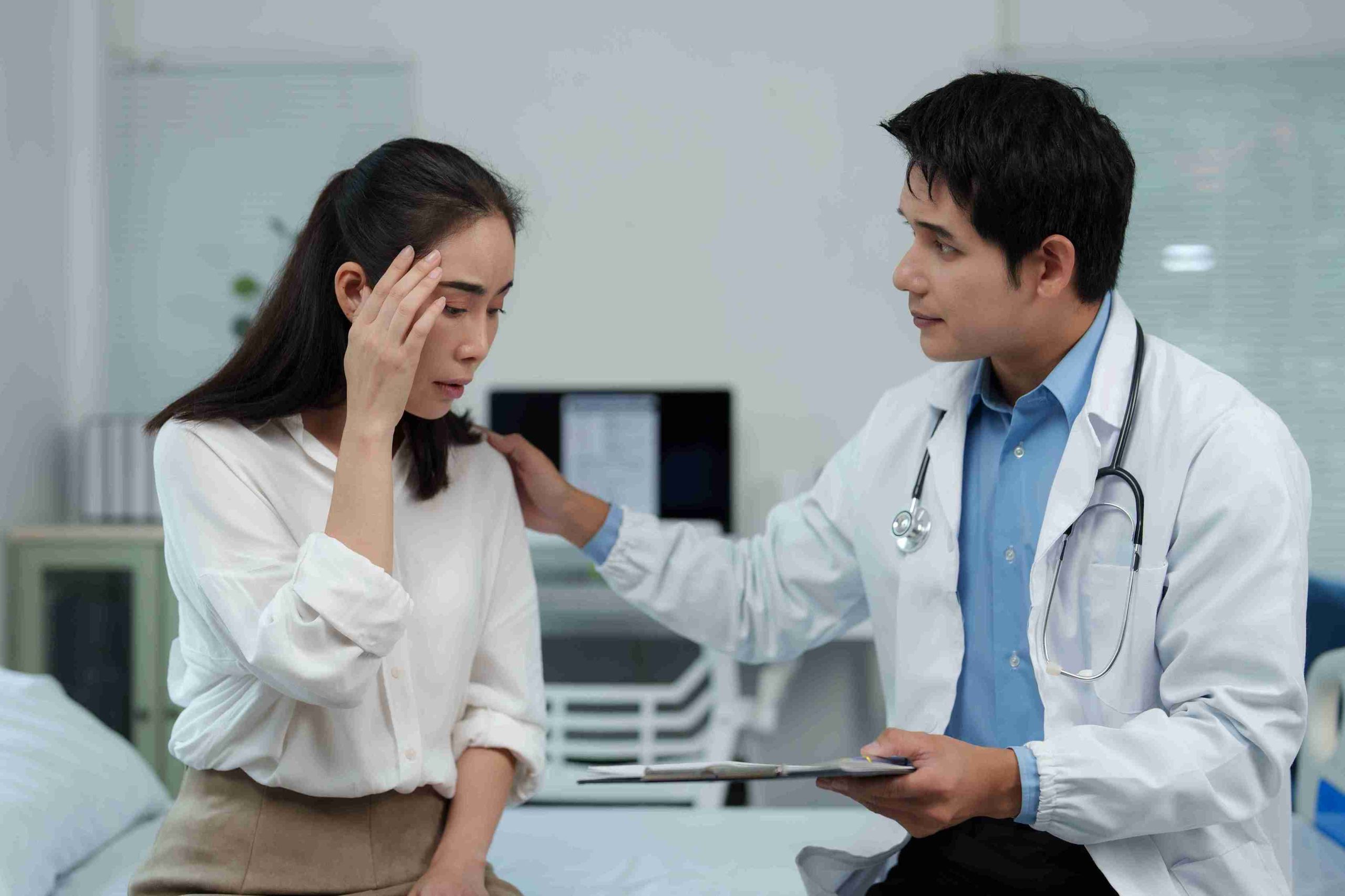 Male doctor comforting a worried patient.