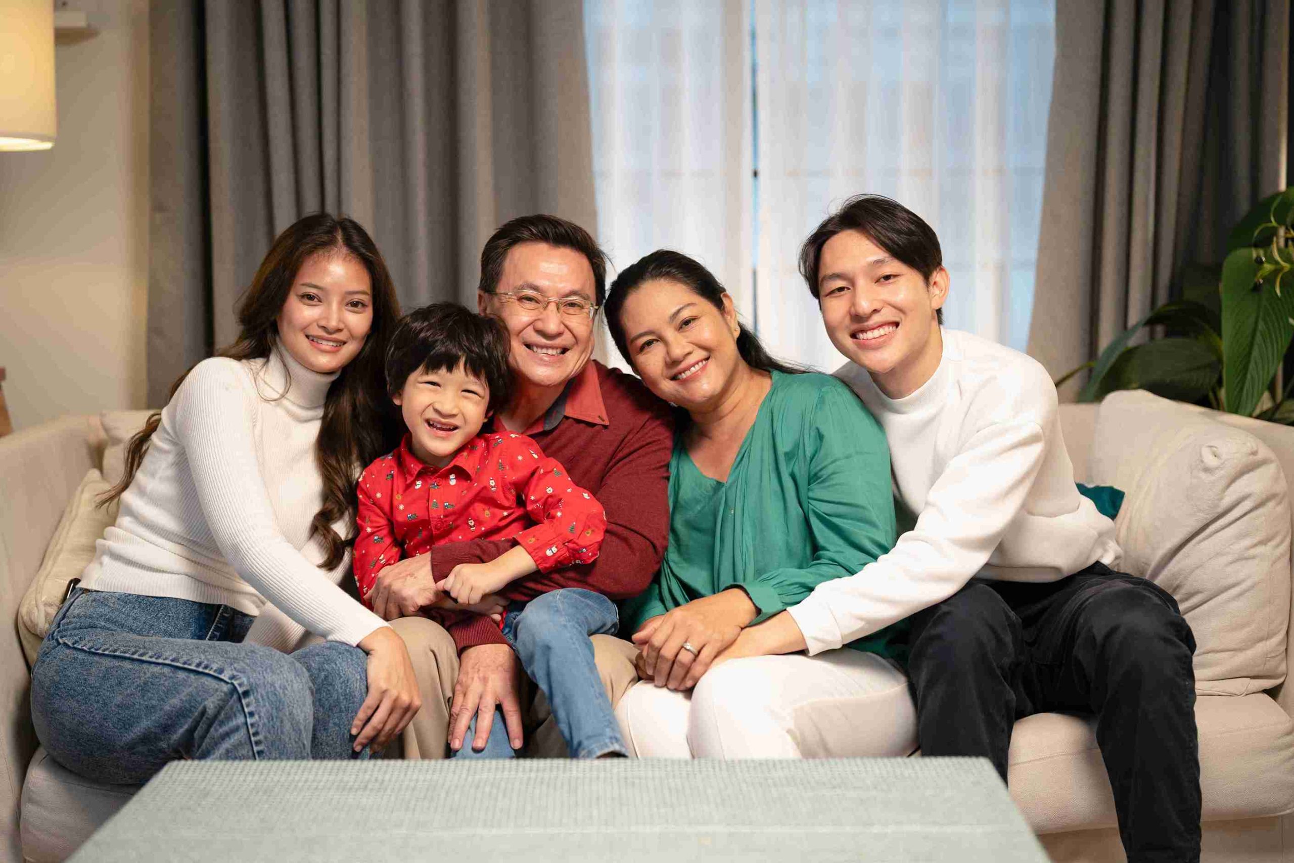 Asian couple posting with their 3 kids.