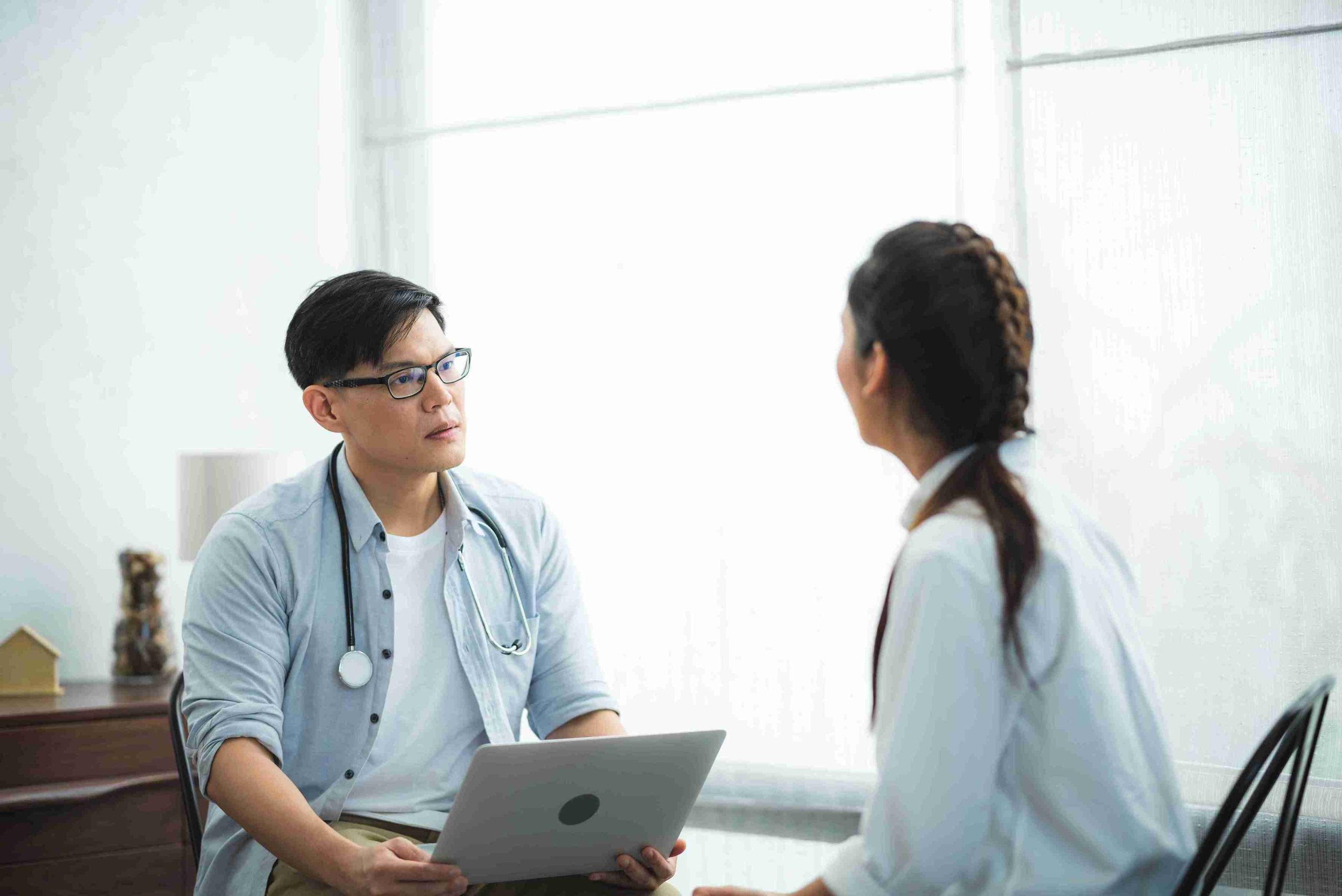 Male doctor listening to his patient.