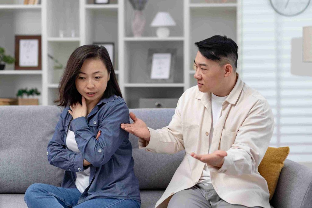Asian couple having a serious discussion.