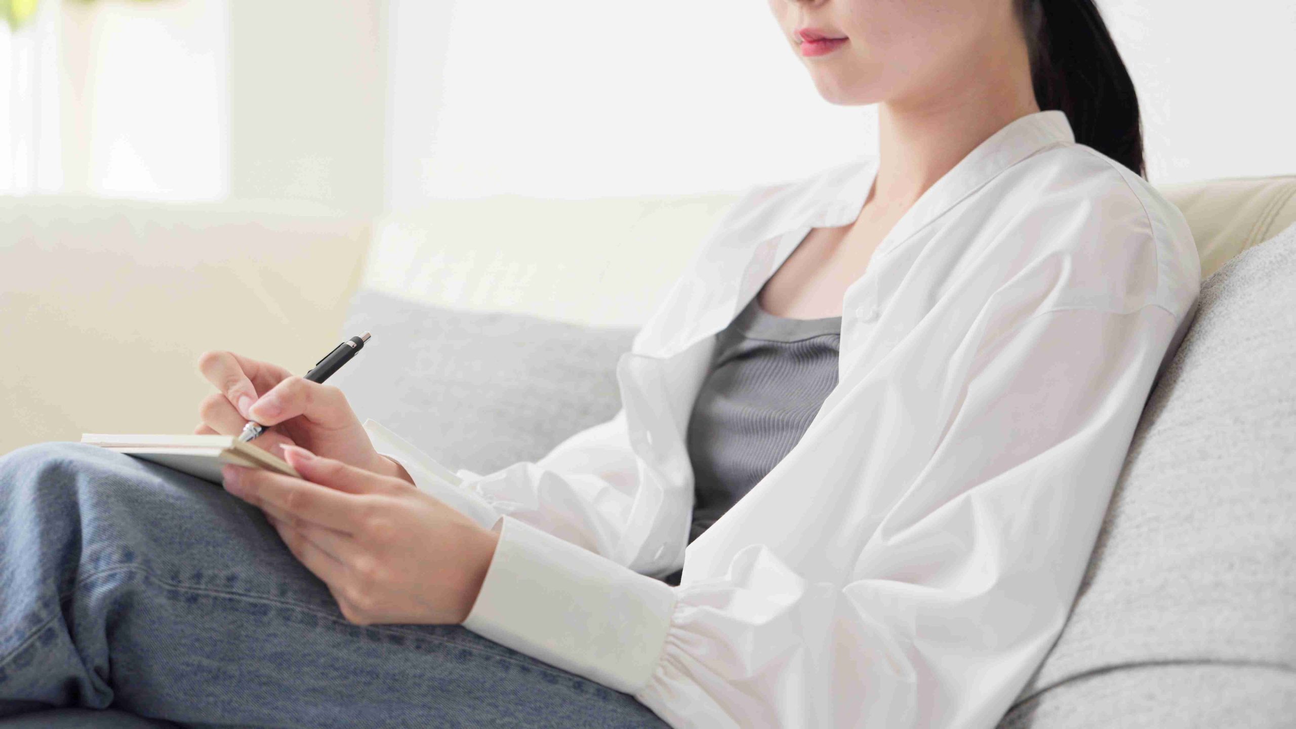 Woman writing down her symptoms.