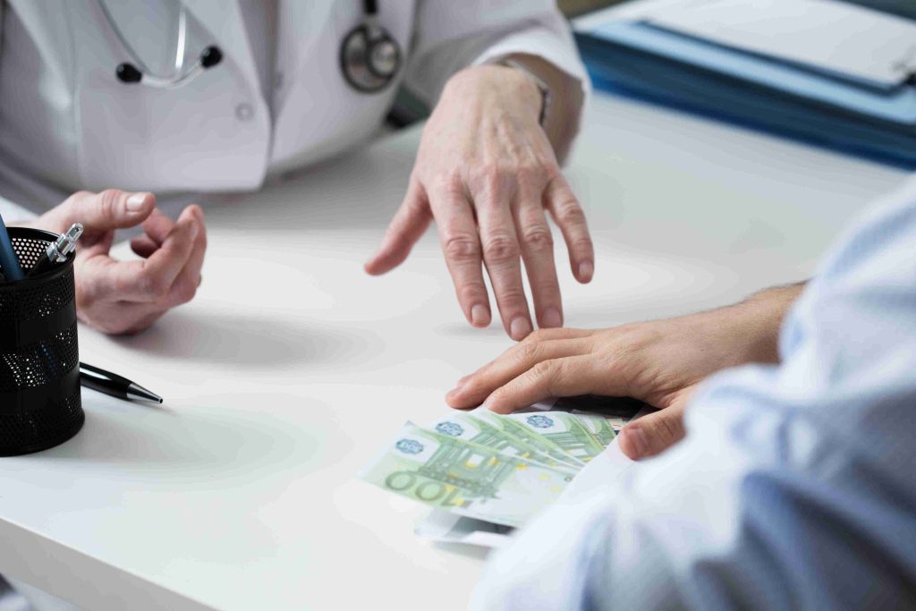 Patient giving money to the doctor.